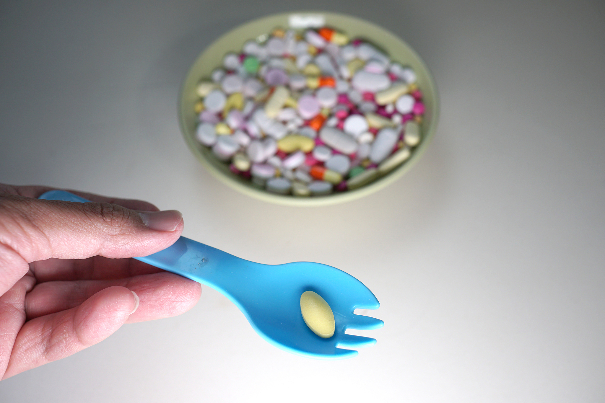 man's hand holding a spoon. with medicine.