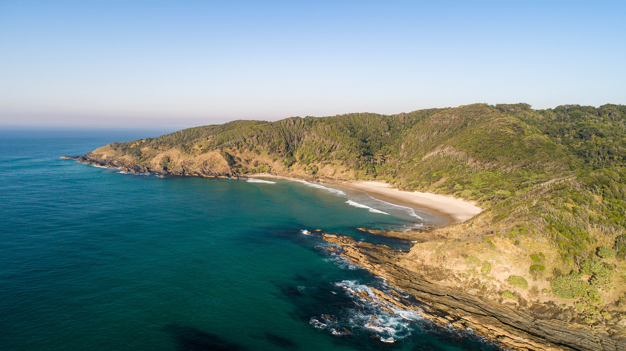 aerial of a spectacular coastal scene with beach, ocean and clif
