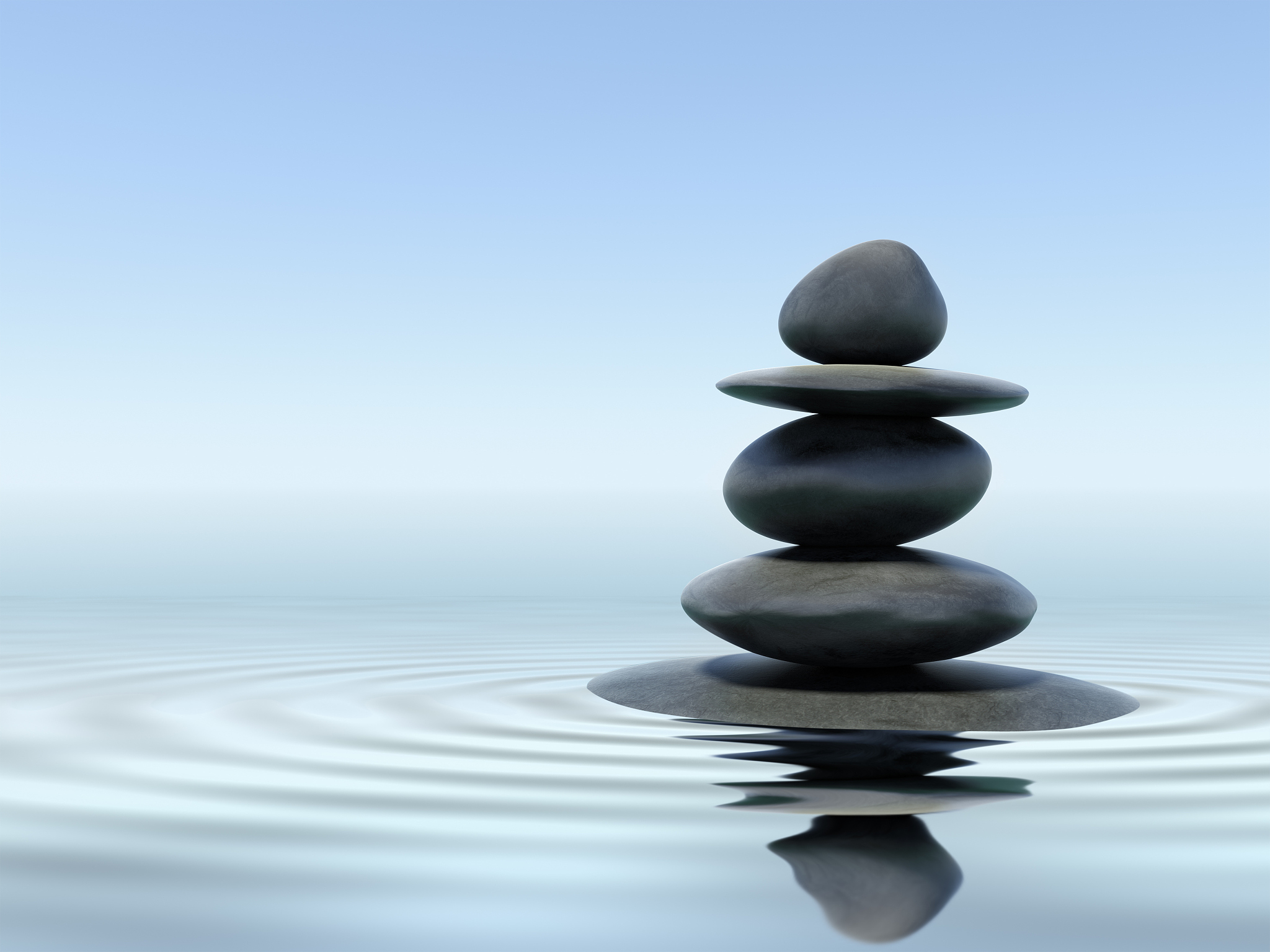 black zen stones in shallow water