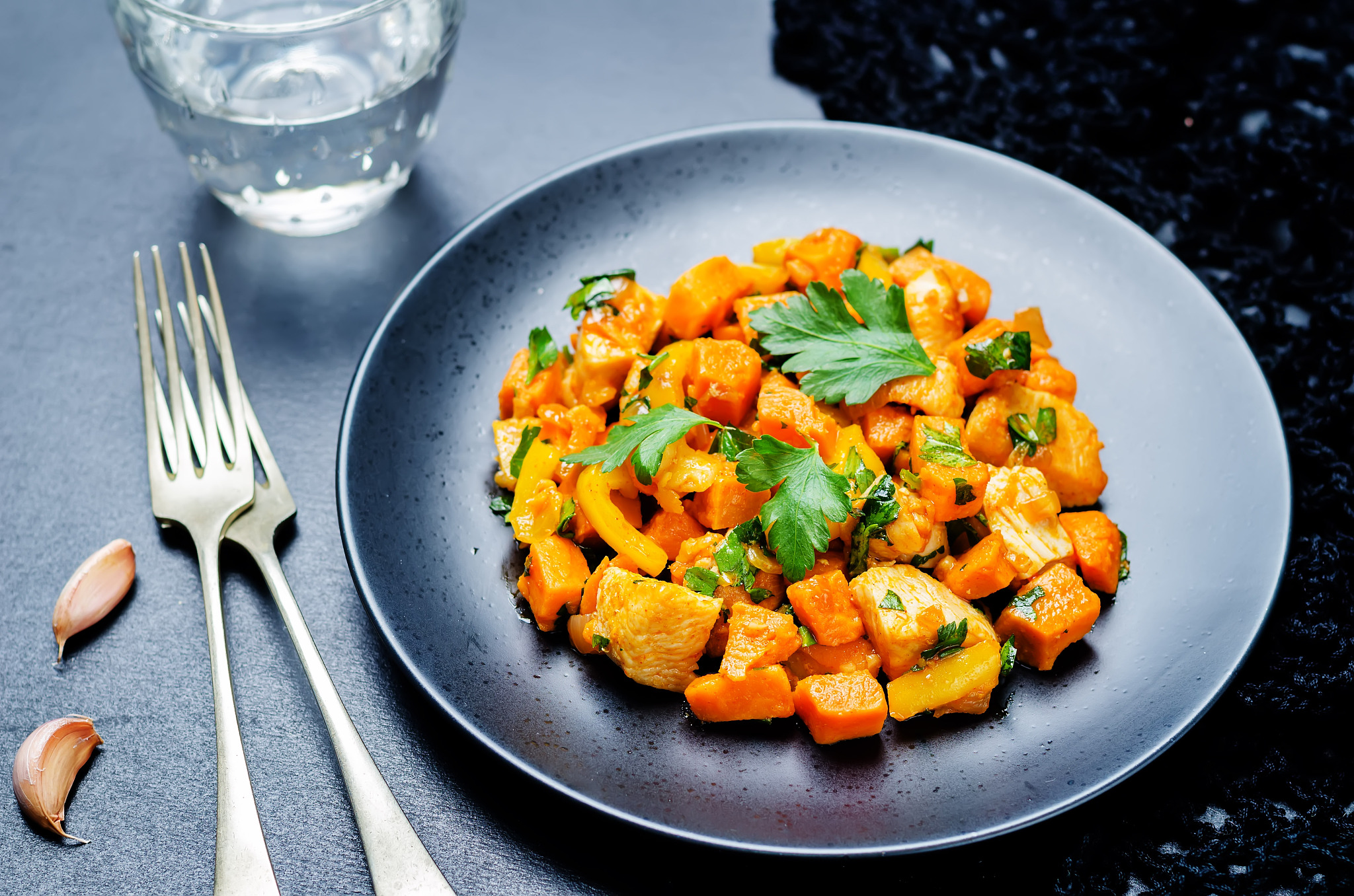 sweet potato chicken skillet with glass of water