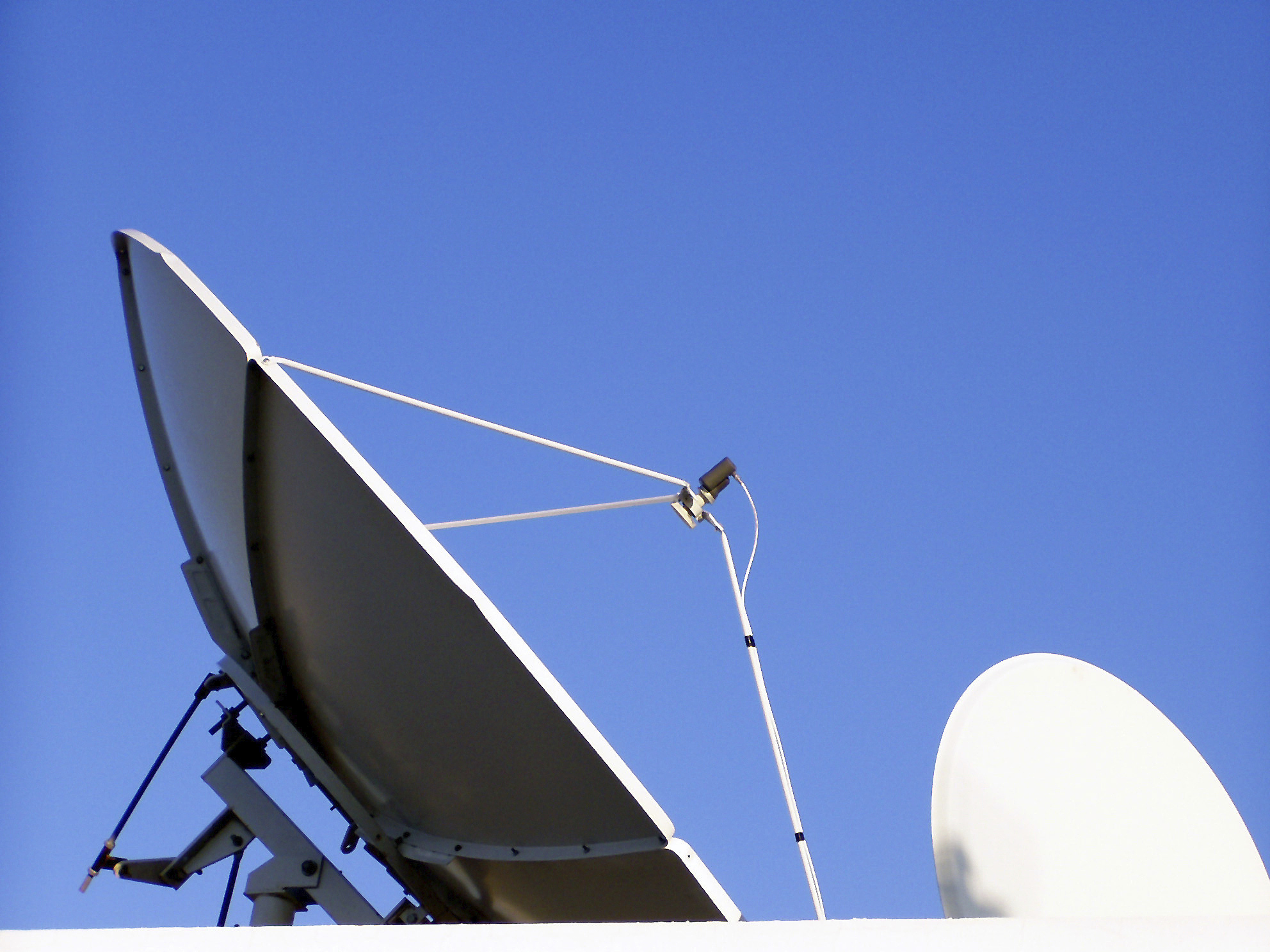 satellite dishes against blue sky