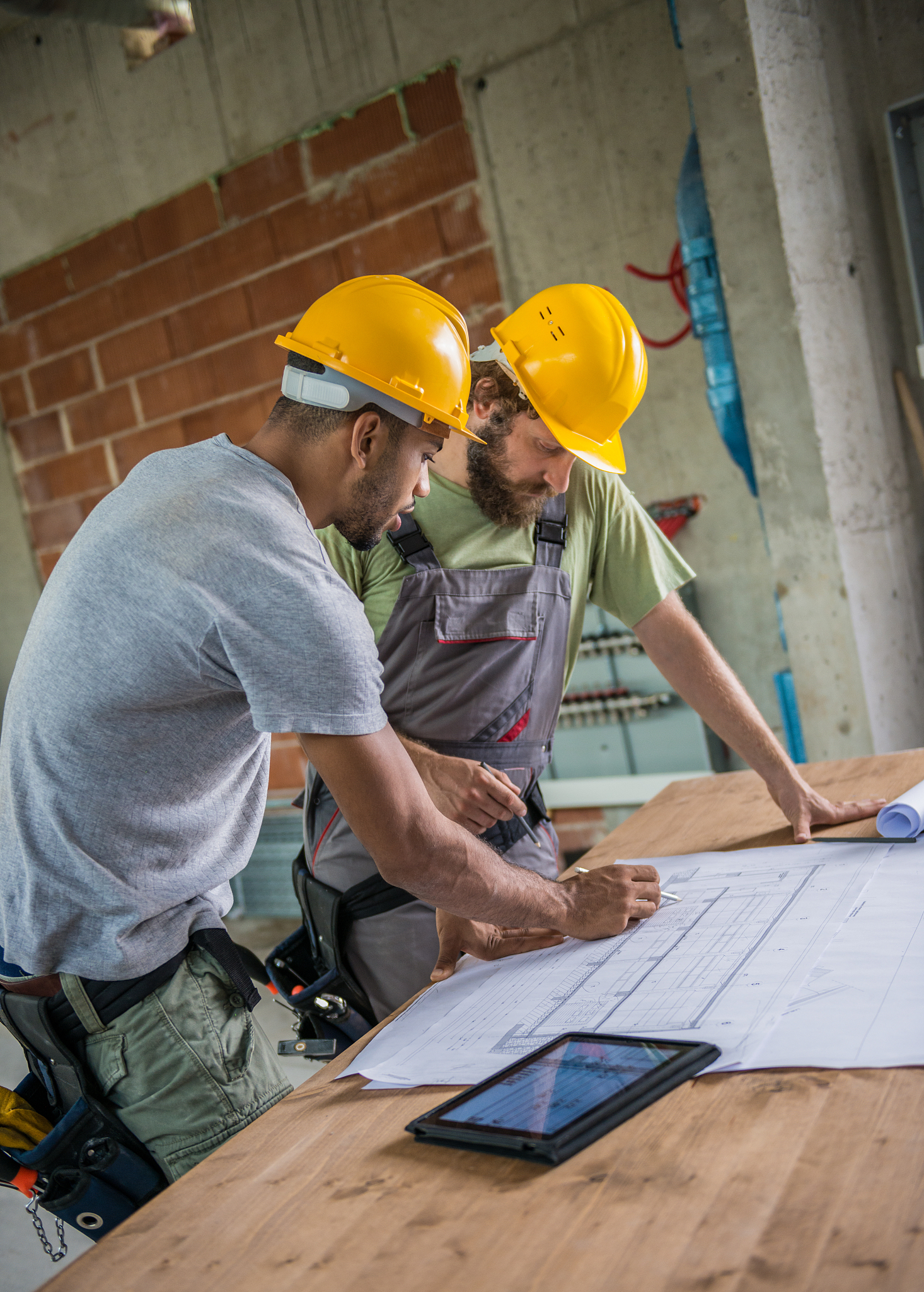 construction workers looking blueprints together