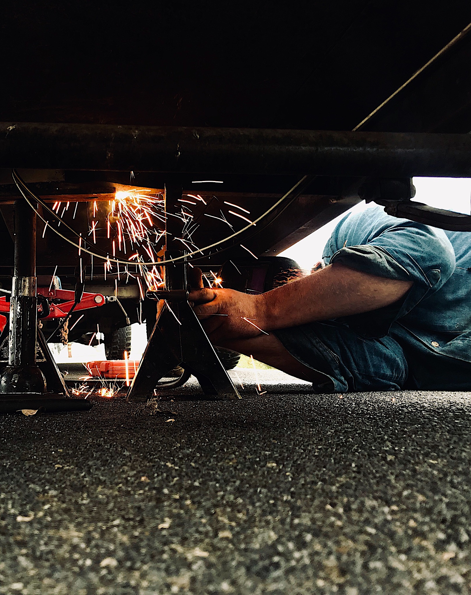 man welding his trailer frame.
