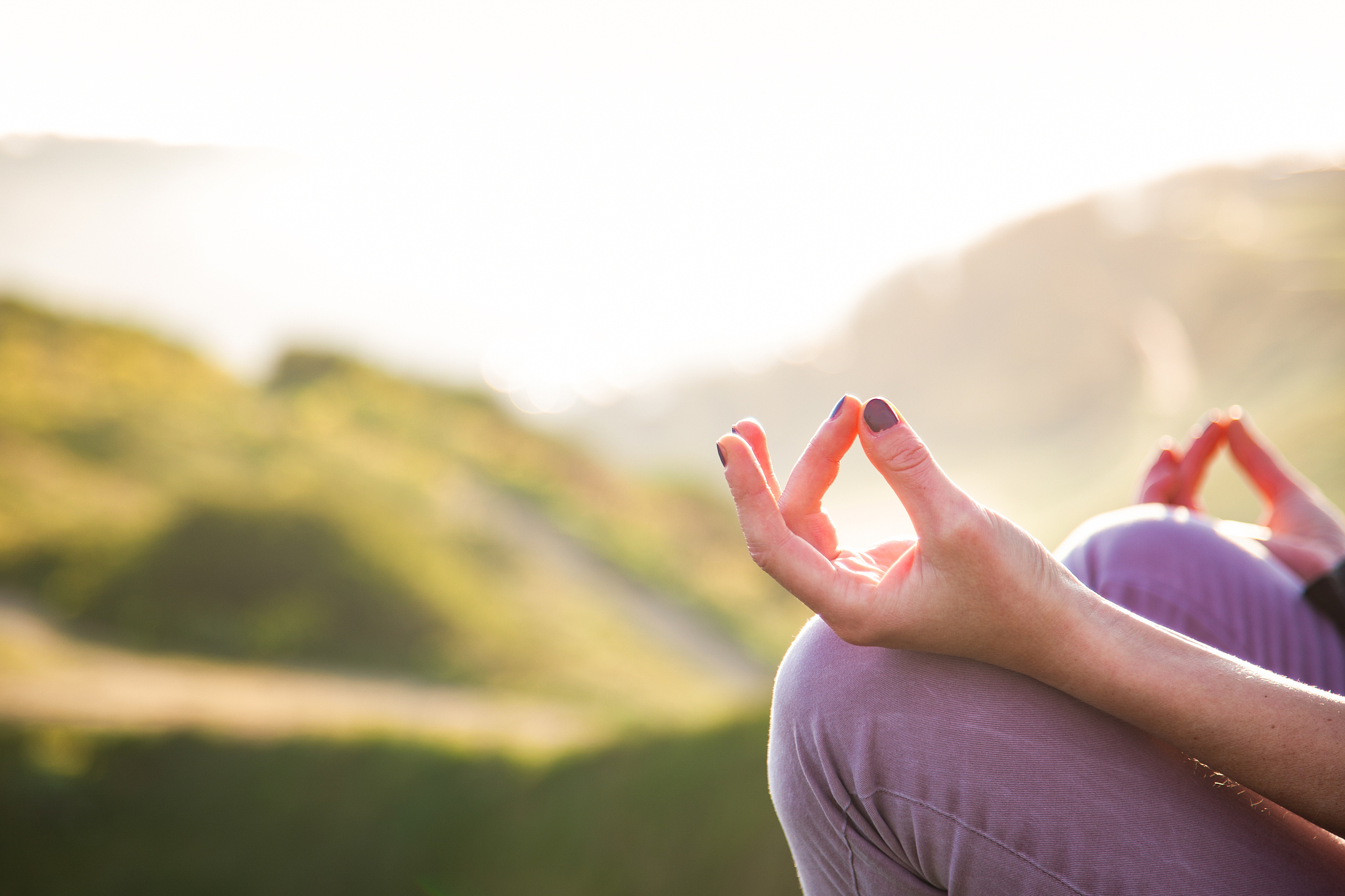 woman doing yoga in beautiful nature background at sunset or sun