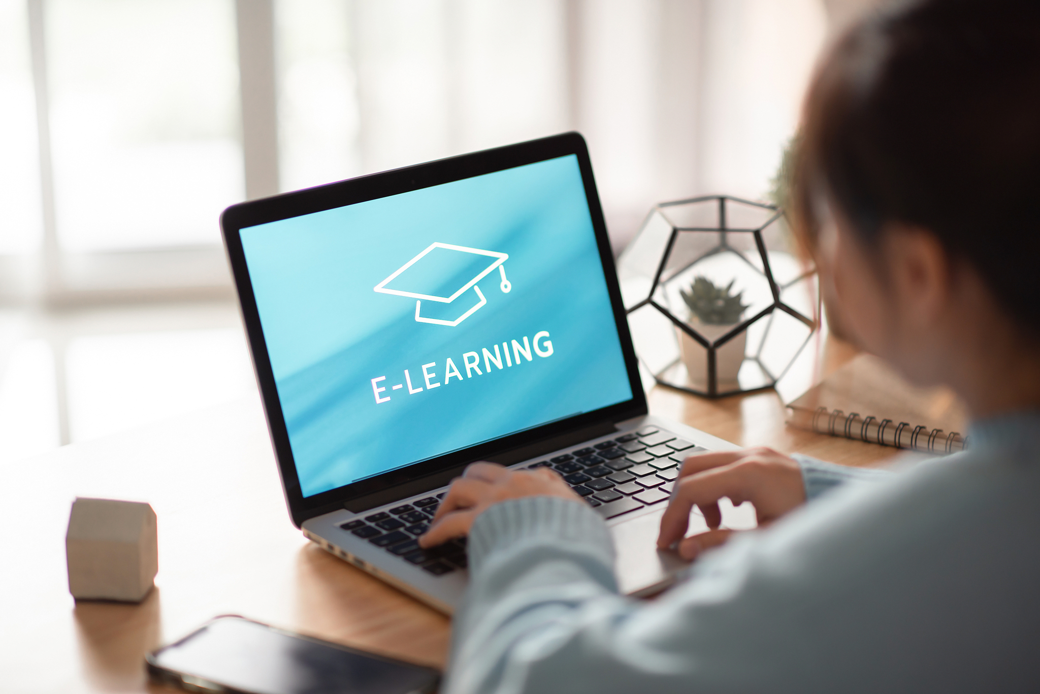 online education, e-learning. young woman is sitting at table, w