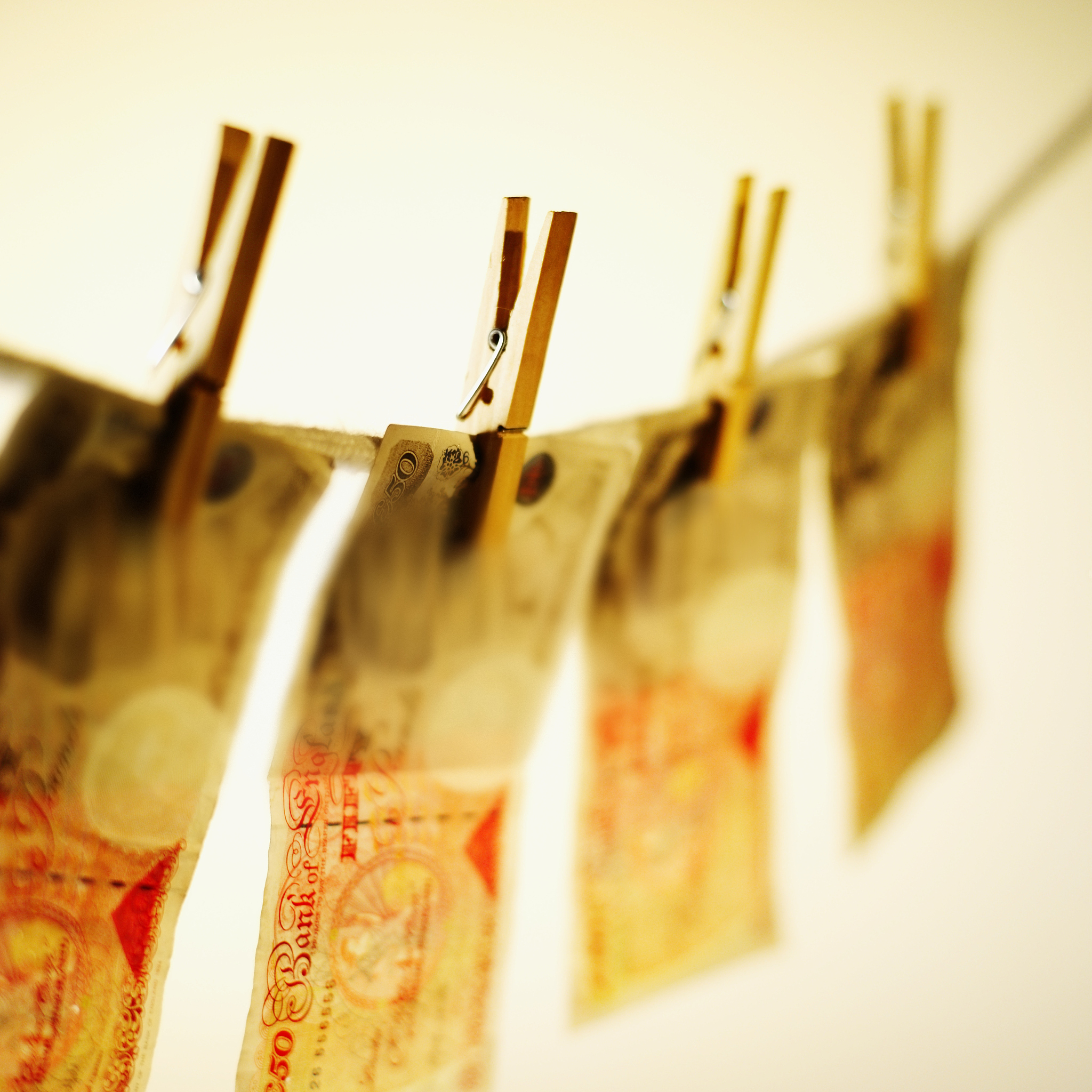 close-up of fifty pound notes hanging on clothesline
