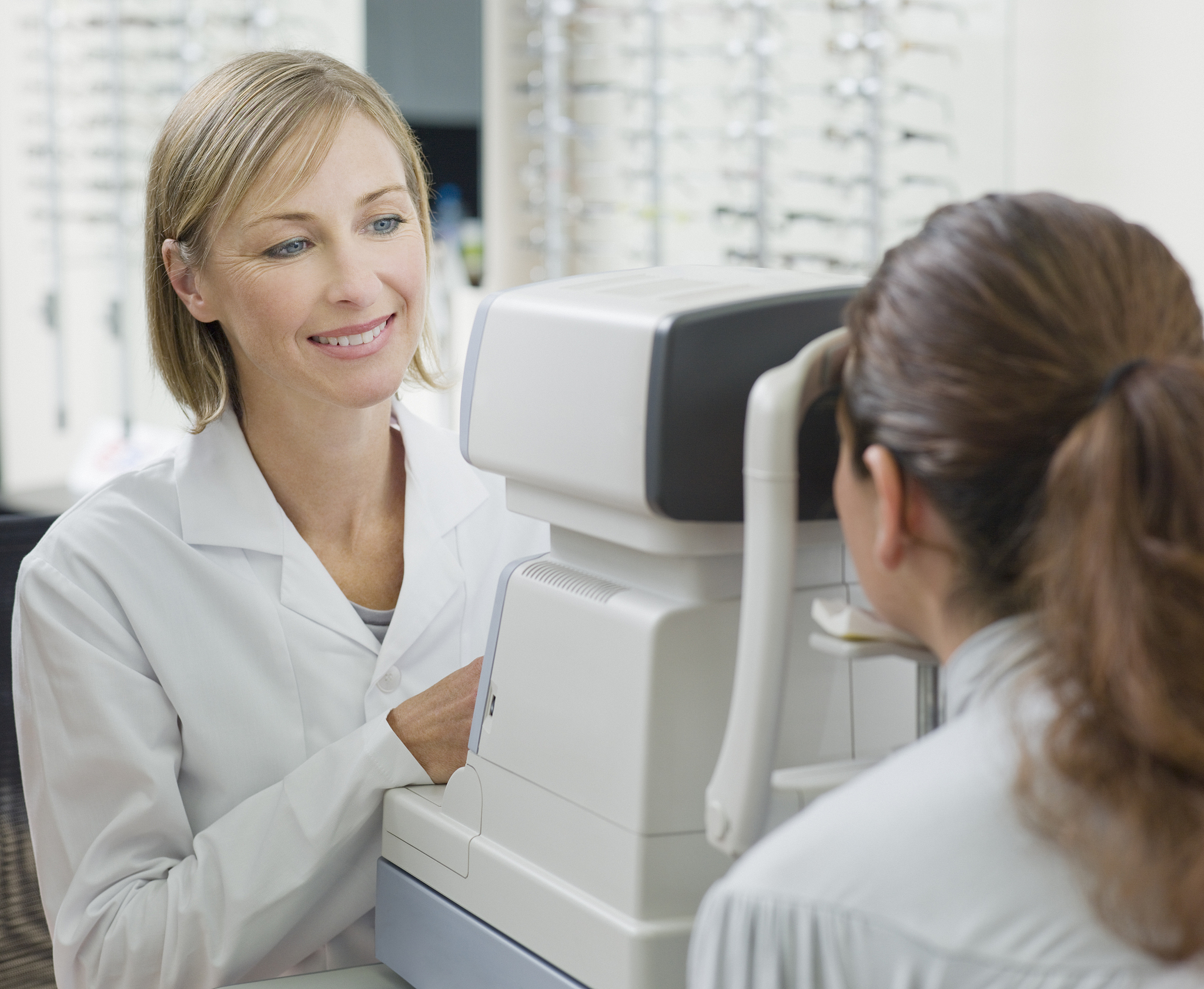optometrist giving patient eye exam