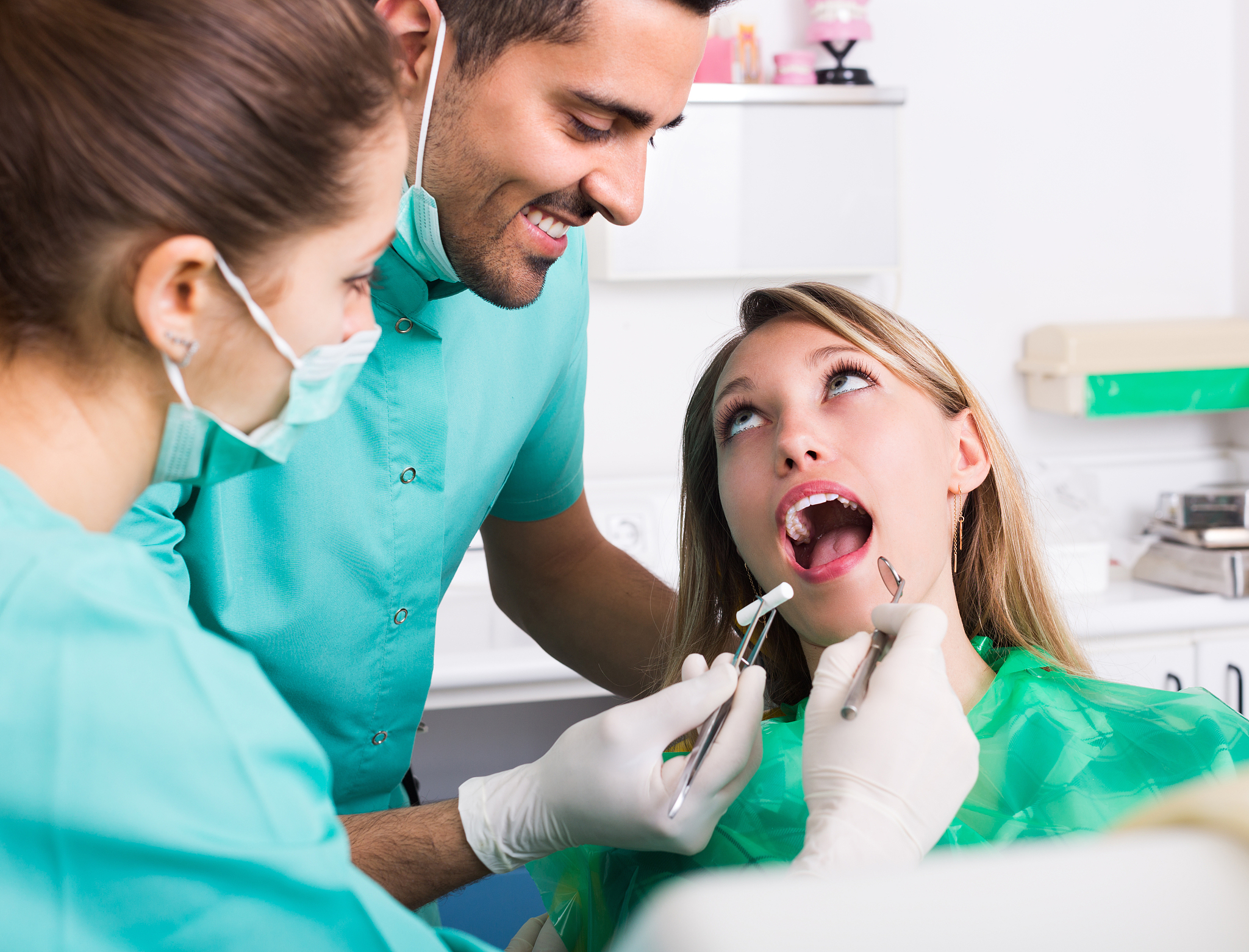 happy patient and dental clinic crew