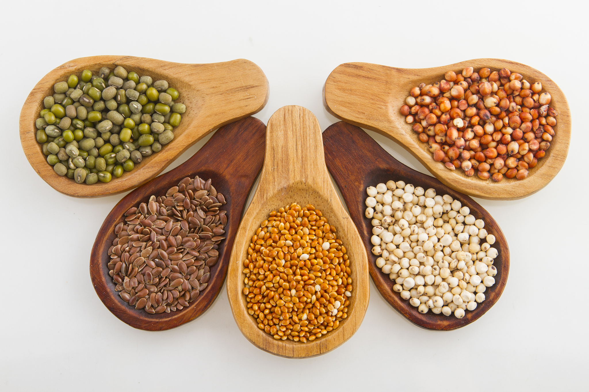 wooden spoons with assorted grains of super foods, gluten free
