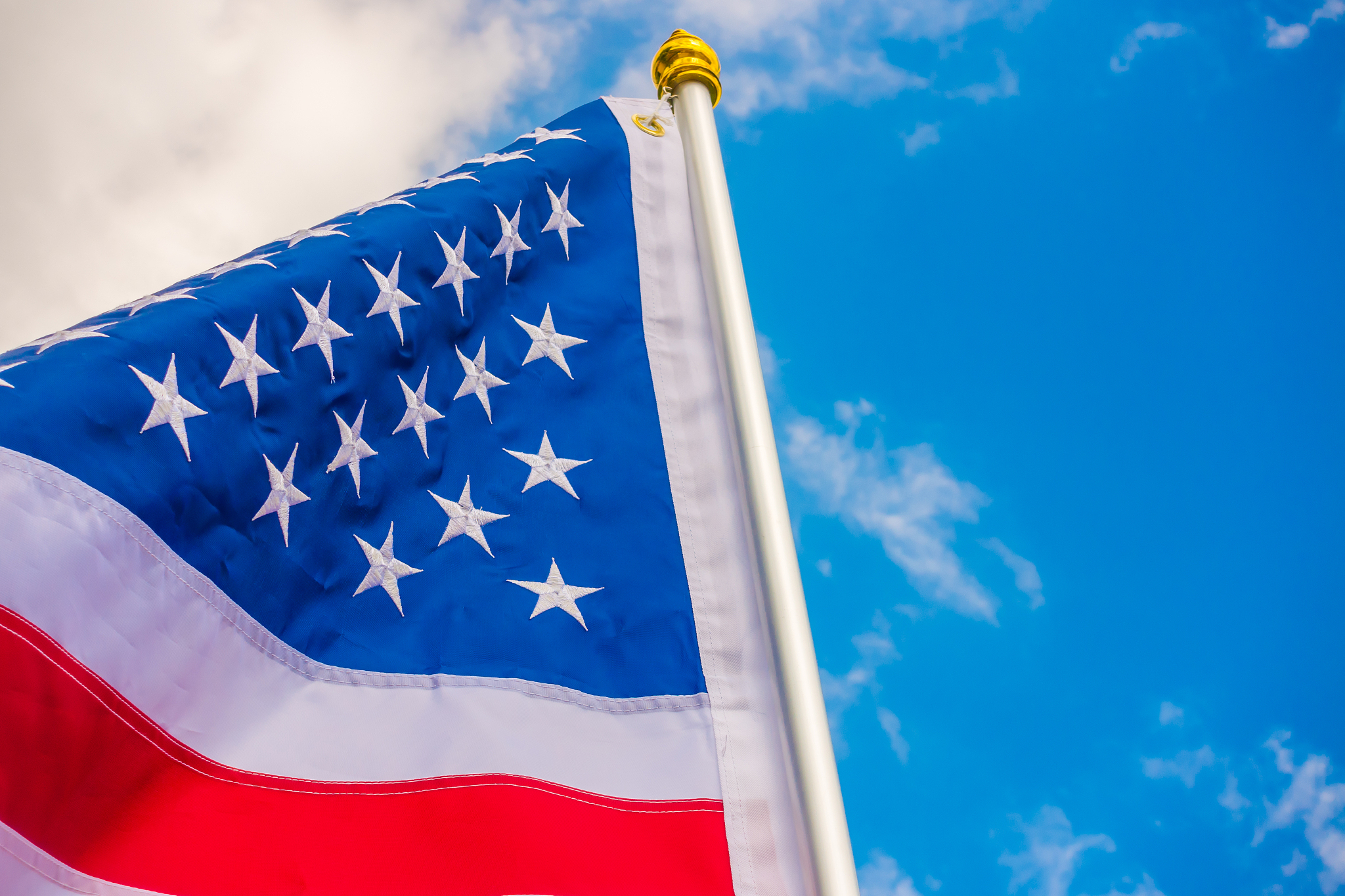 american flag against a blue sky
