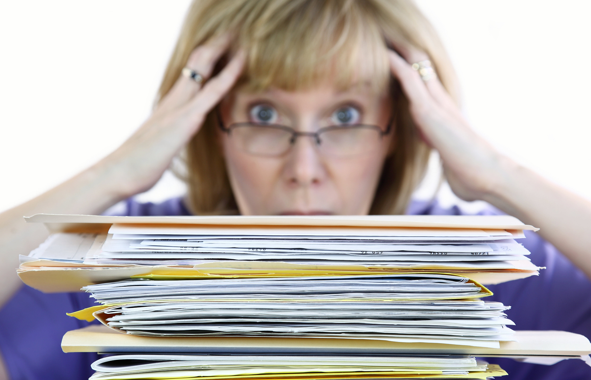 woman stressed by paperwork overload