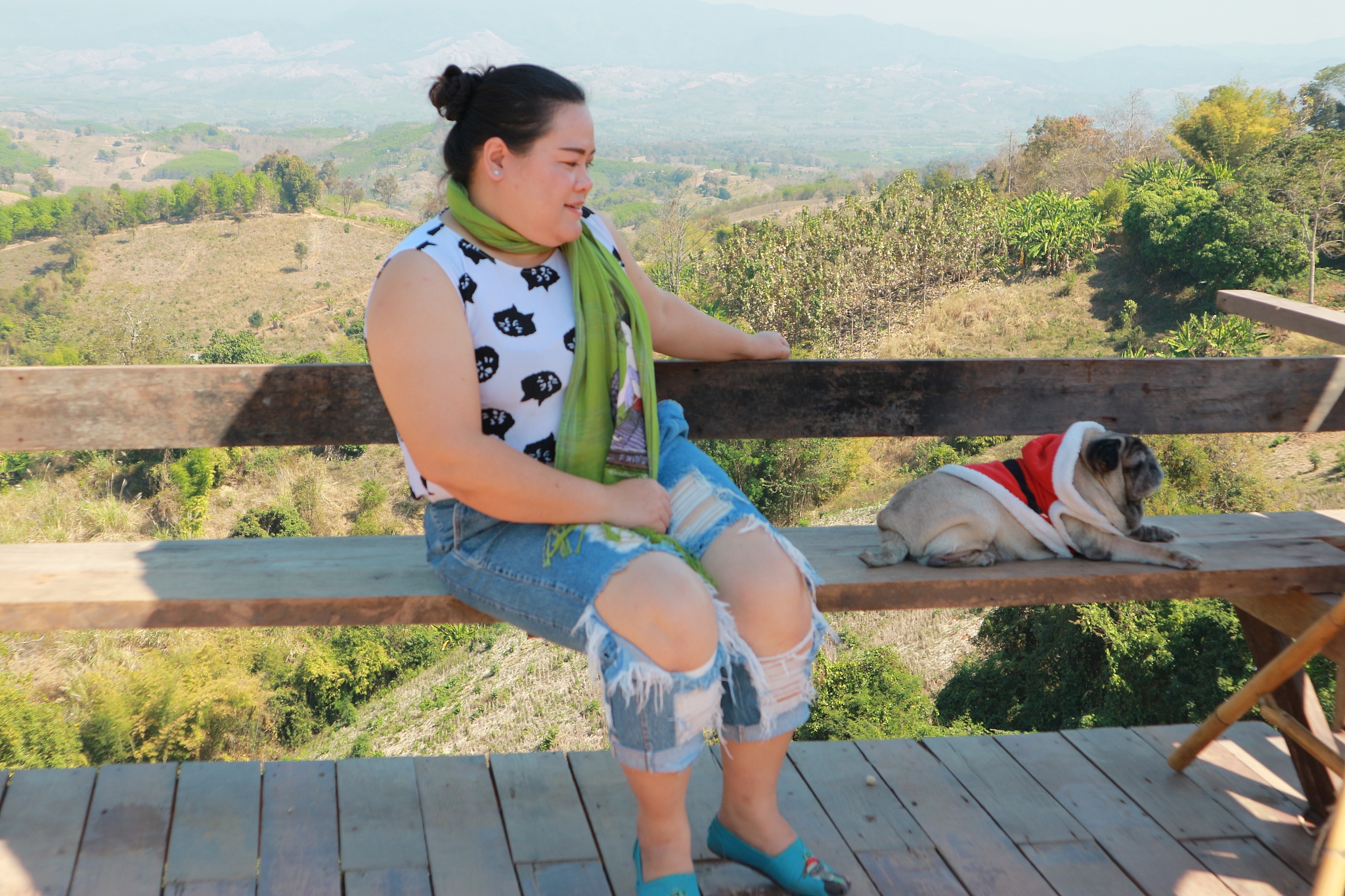 woman with dog sitting on bench