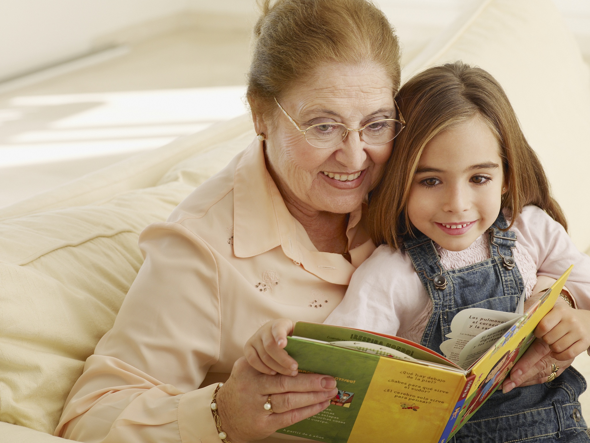 grandmother reading a storybook to granddaughter