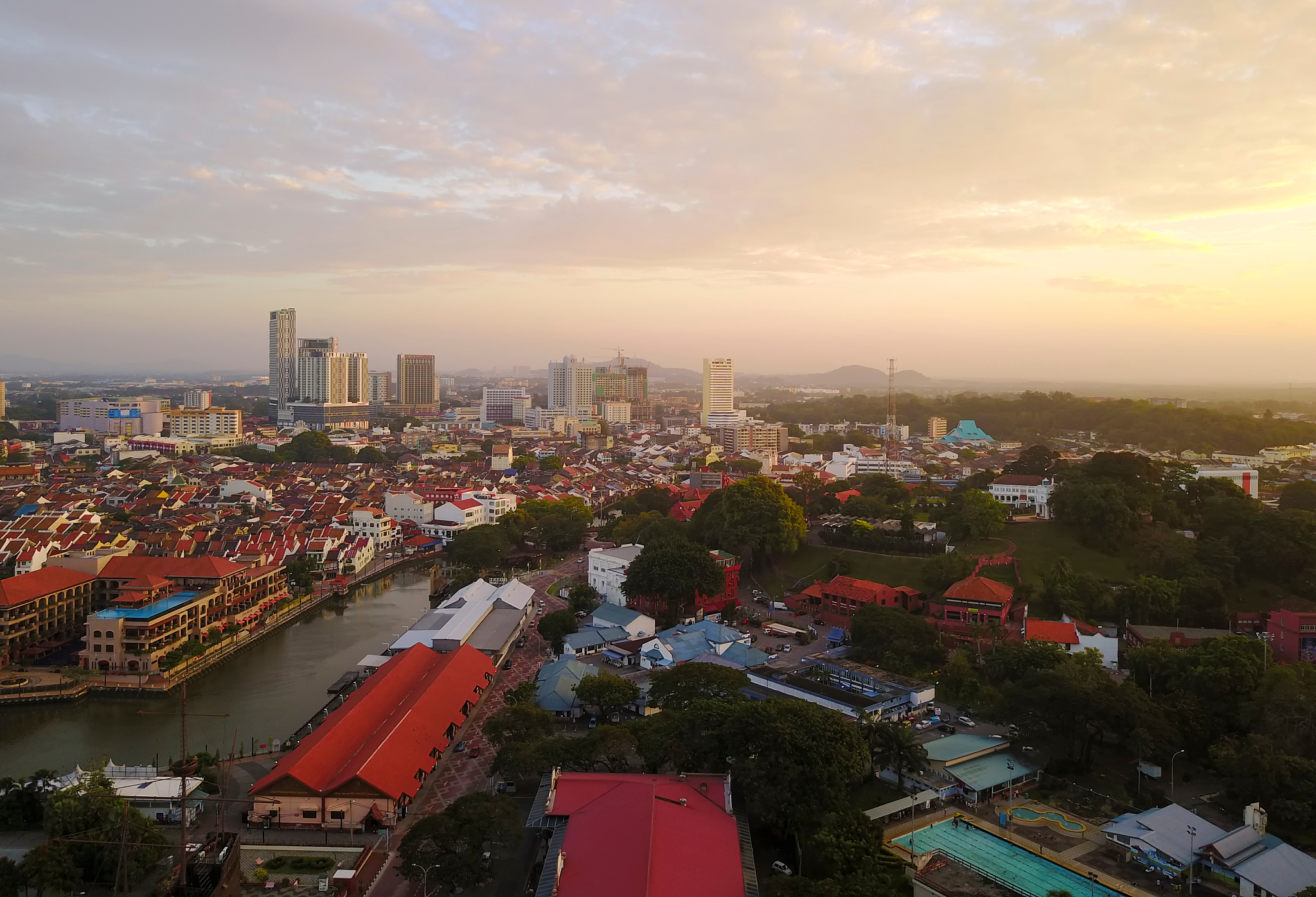 aerial view of city against cloudy sky
