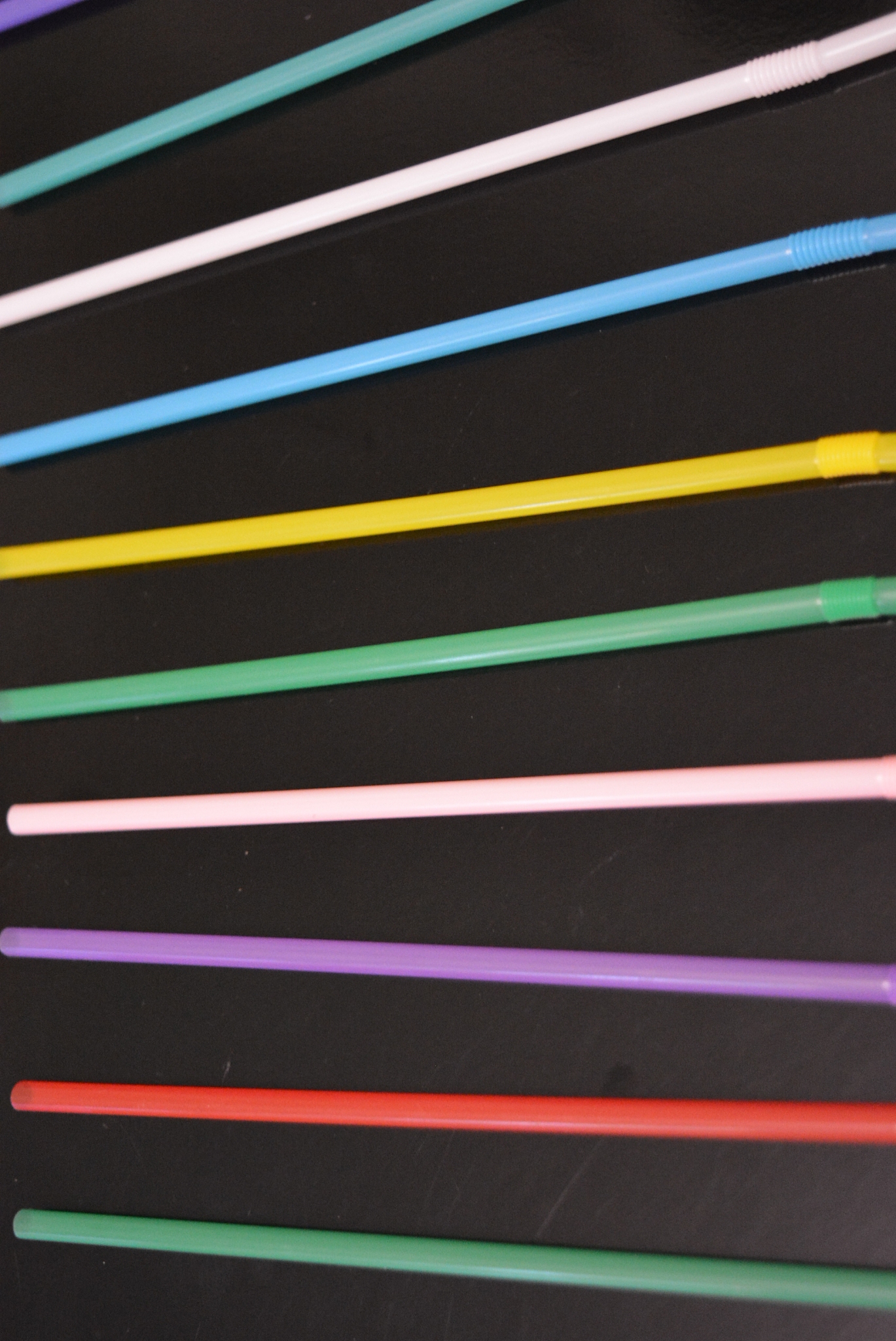 multi-colored plastic stickers, tubes laid out in a graphic and 