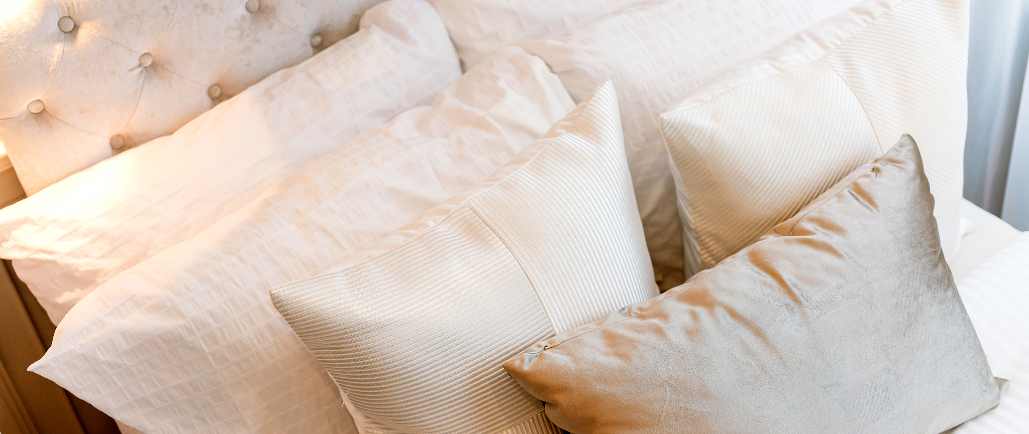 bed maid-up with clean white pillows and bed sheets in beauty be