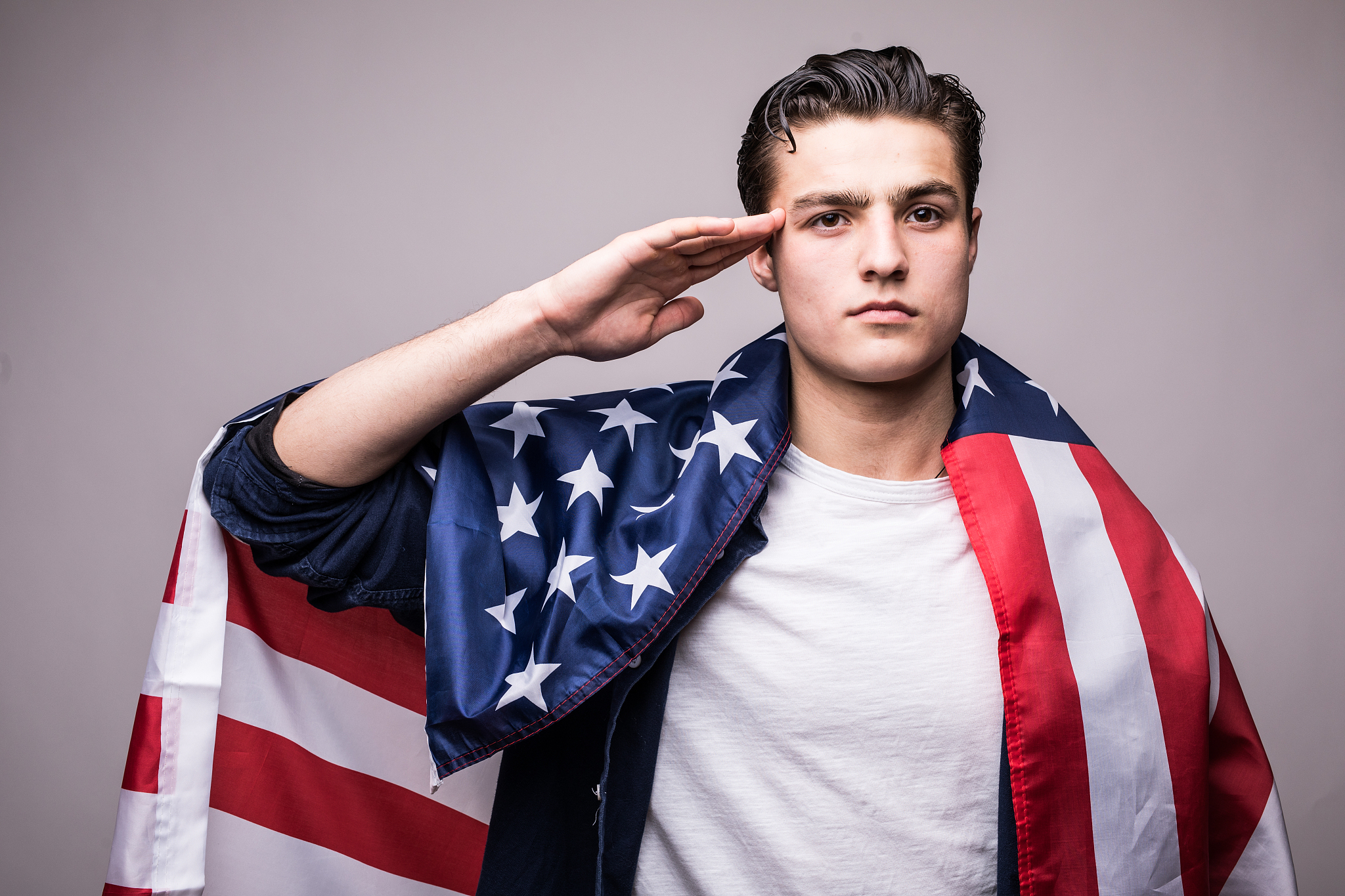 man in american flag salutes