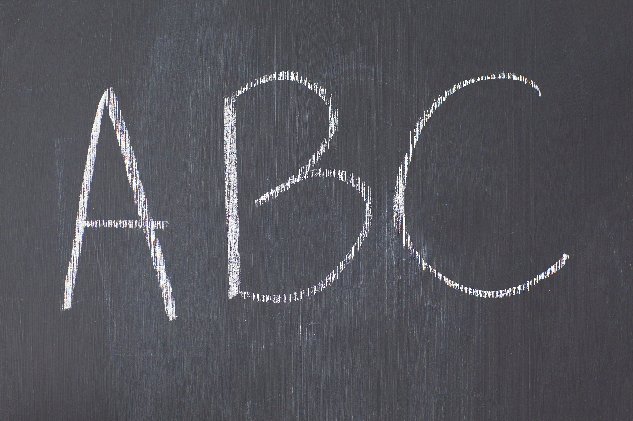 close up of a blackboard with letters written on it