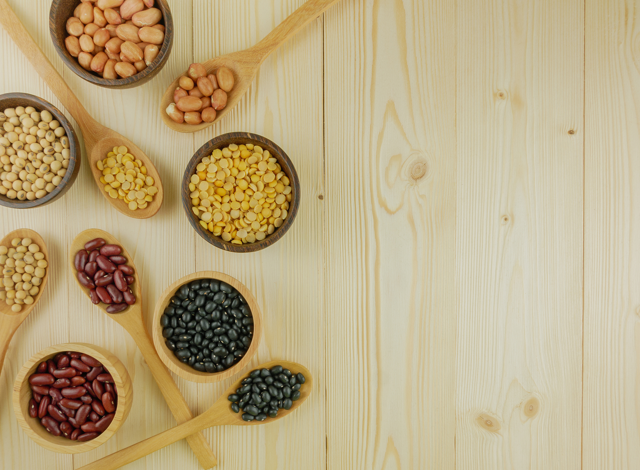 top view assorted beans on wooden background
