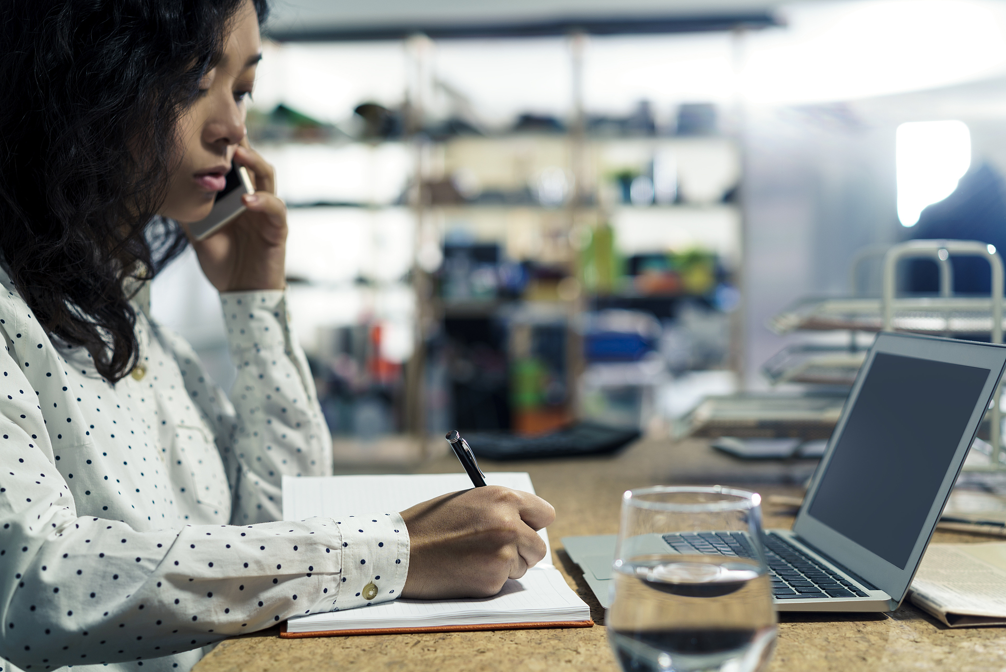 asian girl with phone writing