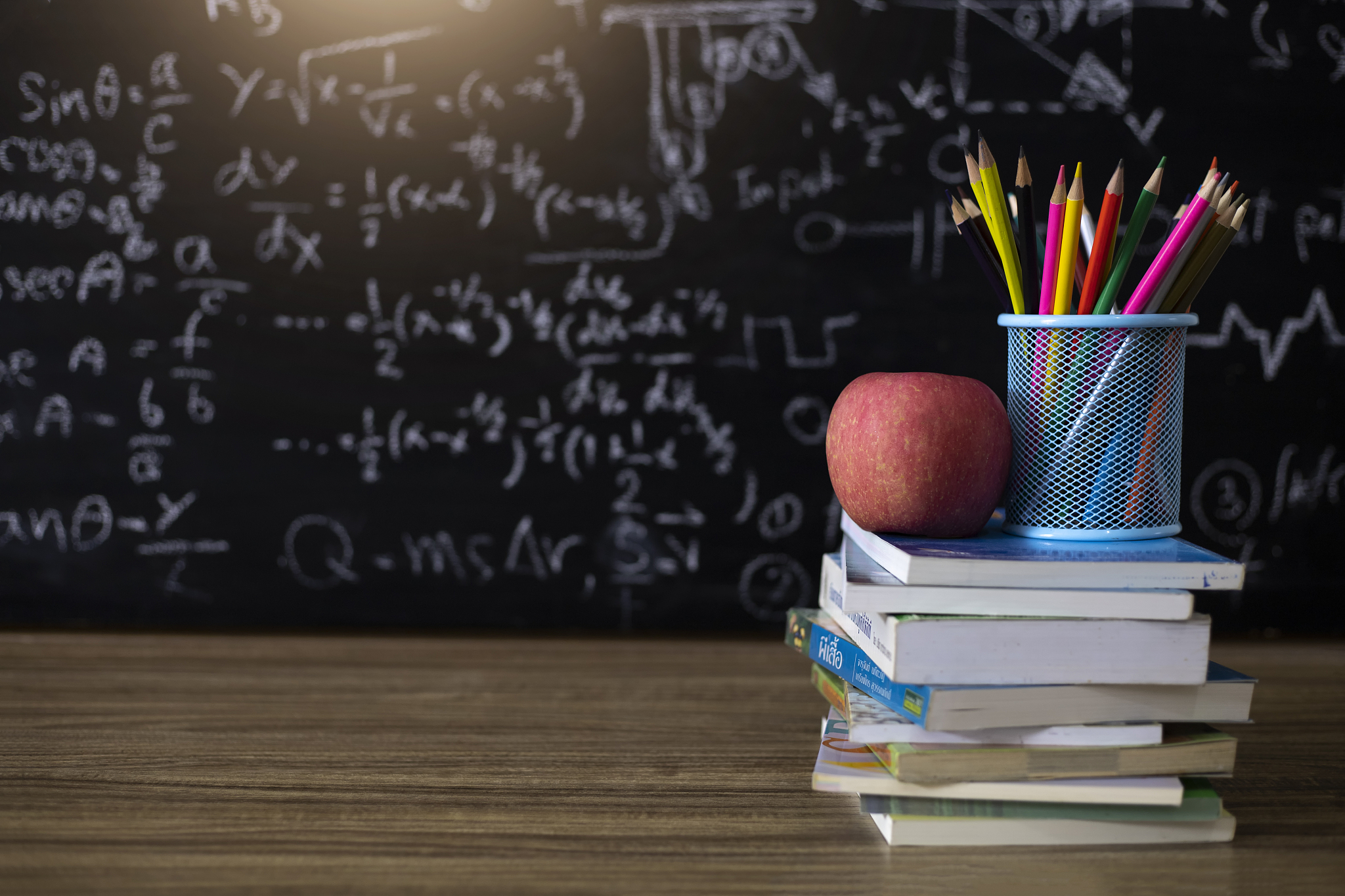 education concept,book and colored pencil on school table