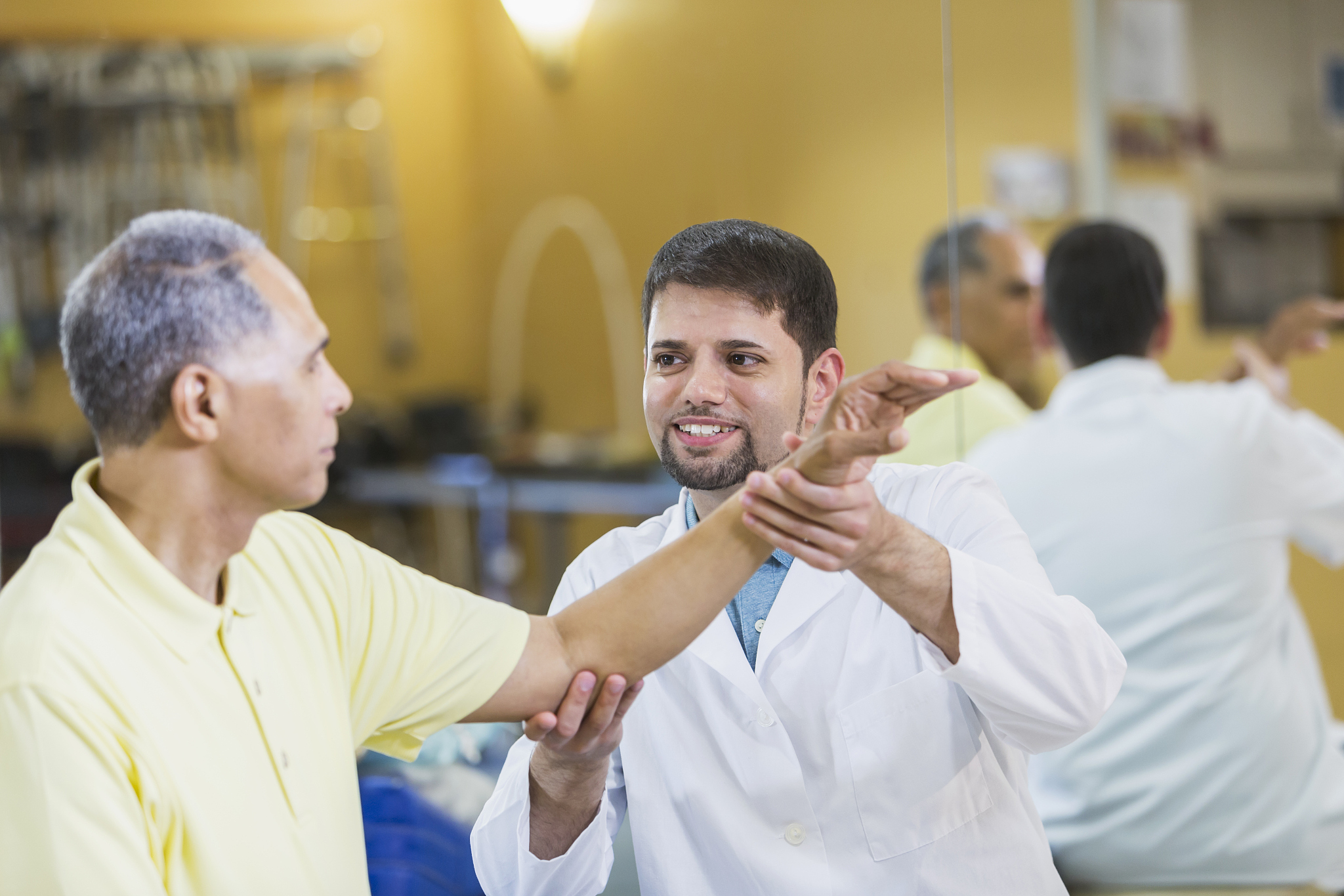 hispanic physical therapist, african american patient