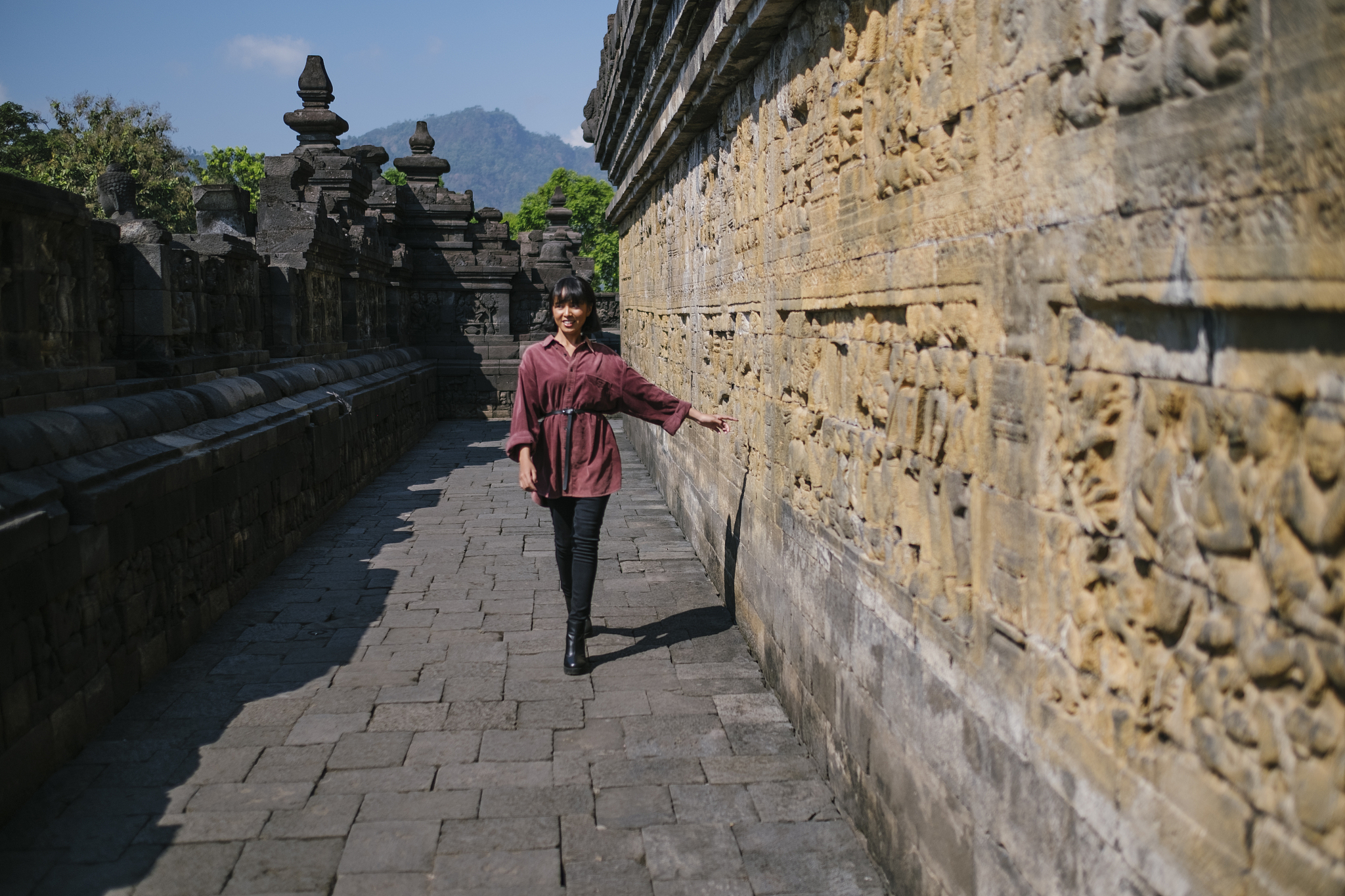 full length of woman walking by historic building