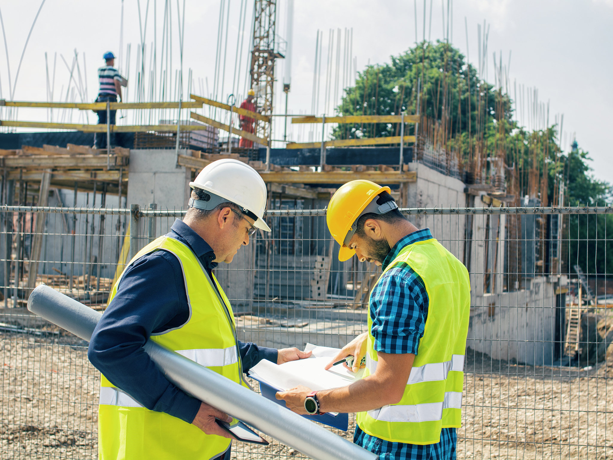engineer and construction site manager dealing with blueprints a
