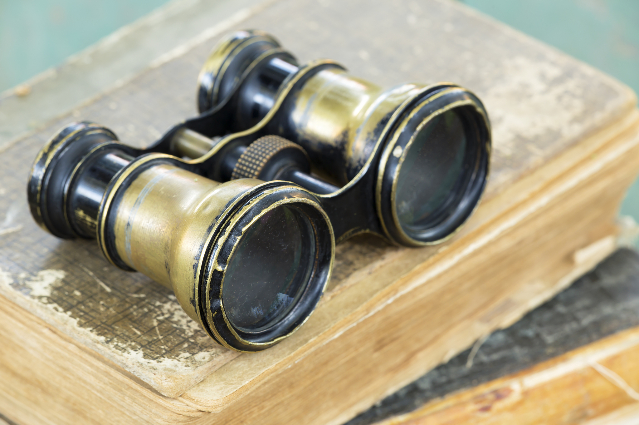 binoculars on books, wisdom, knowledge concept
