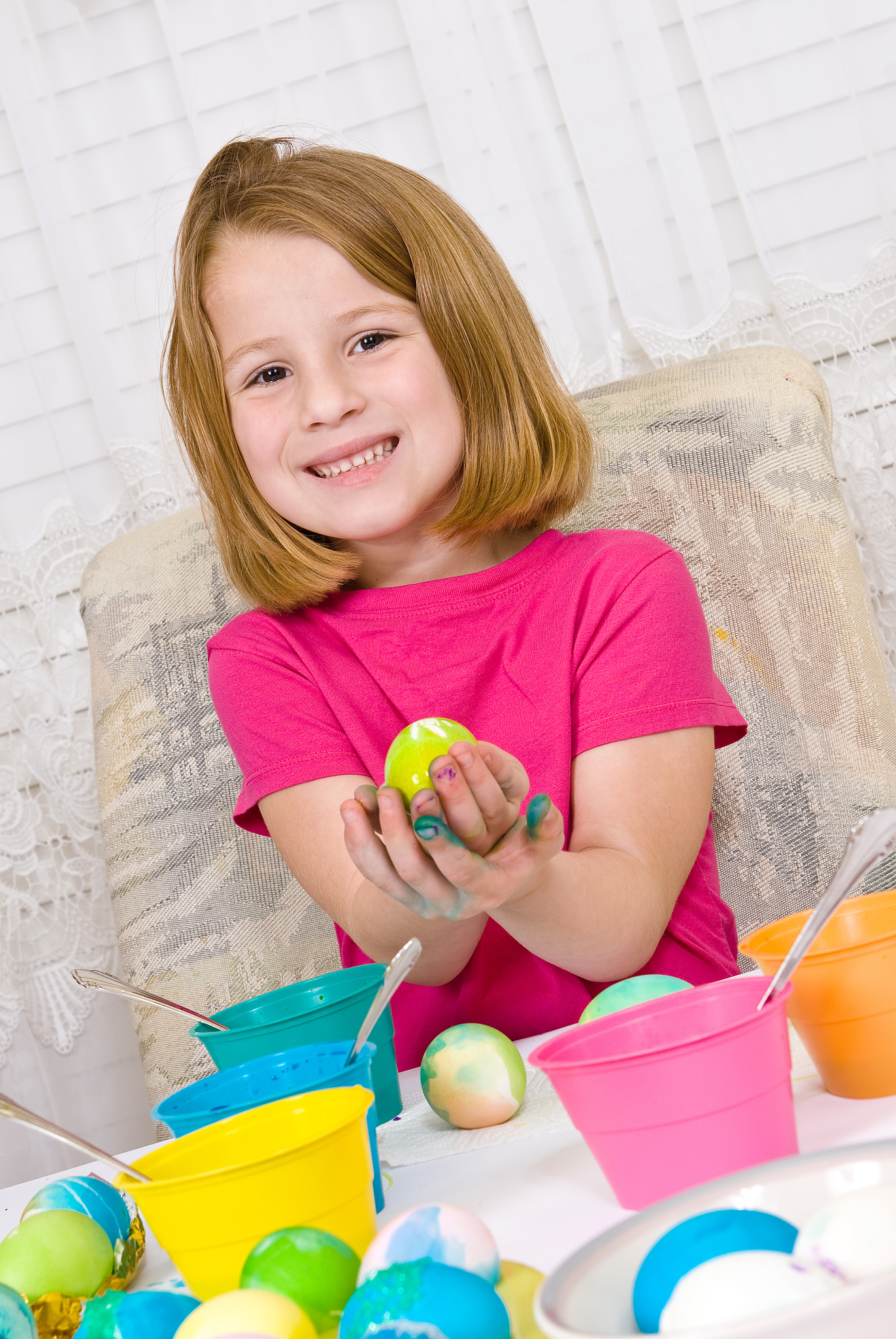 young girl coloring easter eggs