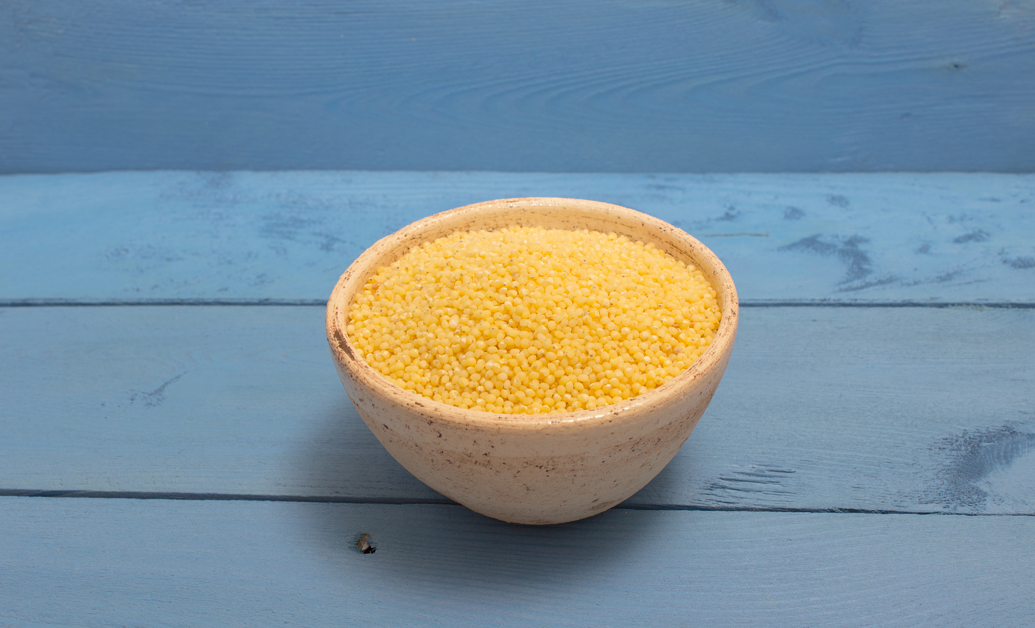 millet groats on the blue board