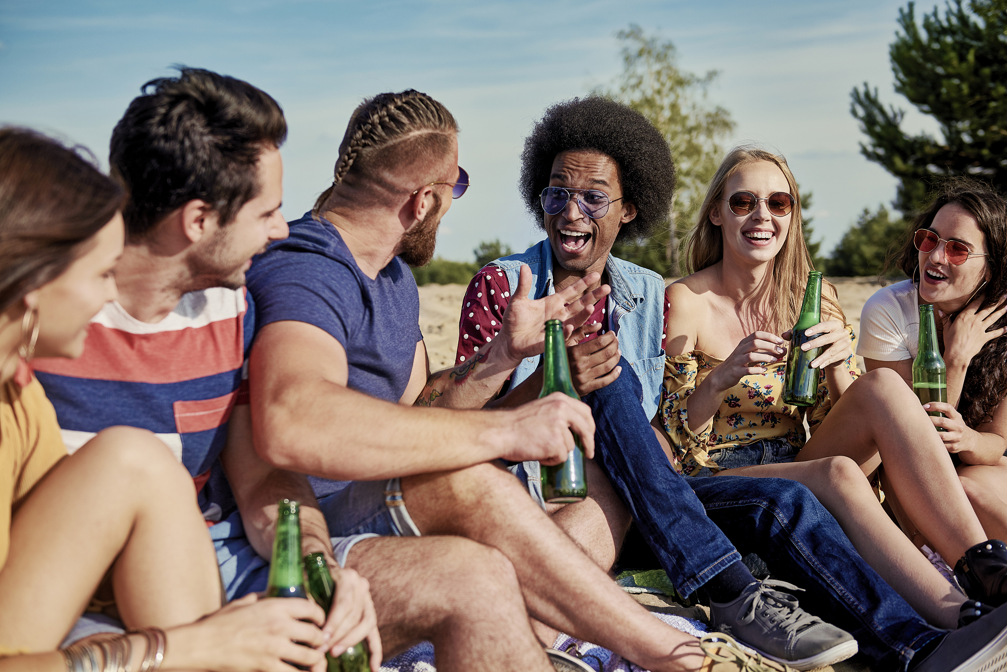 six young people drinking beer outside