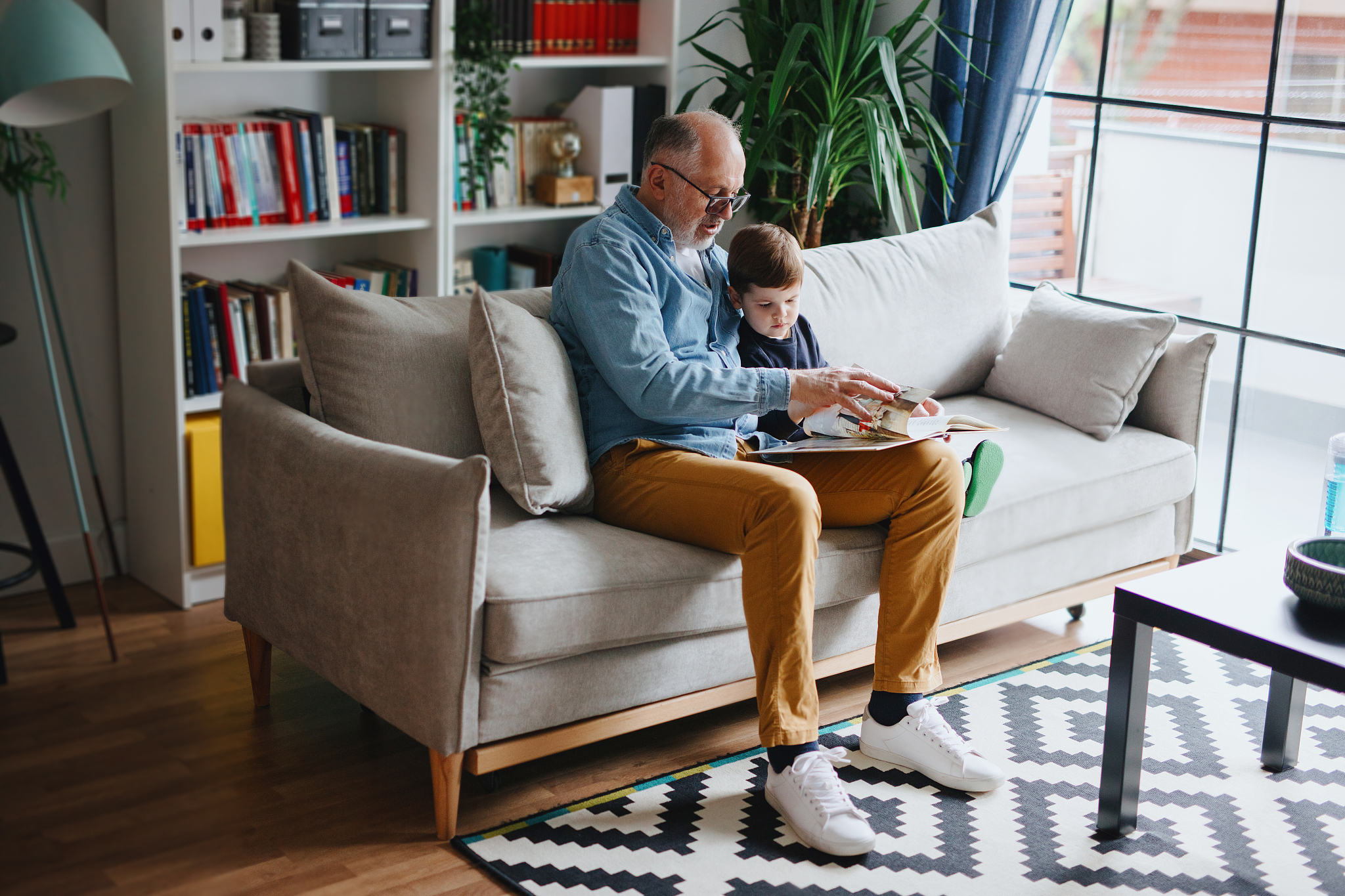 grandfather reading book with his grandson