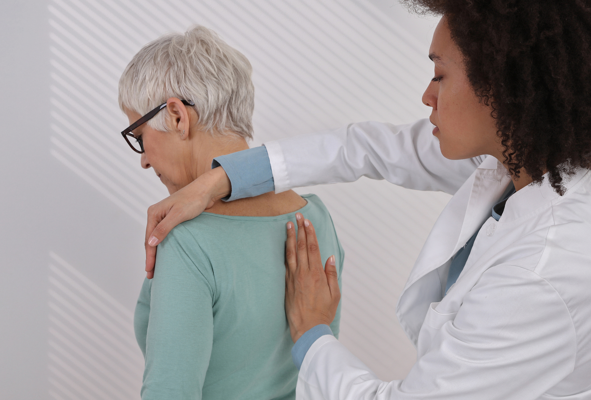 mature woman having chiropractic back adjustment. osteopathy, ph