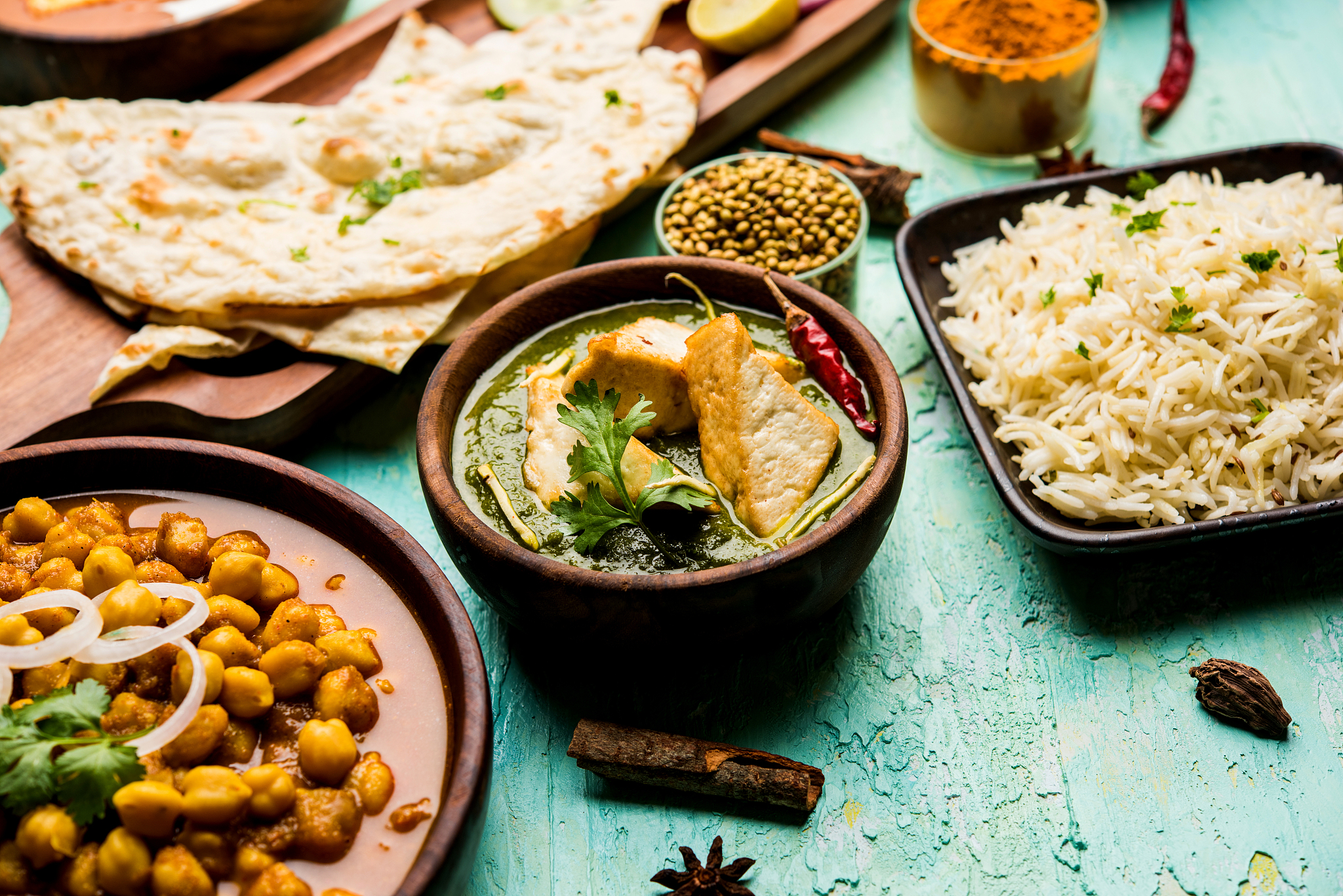 group of indian food like palak paneer butter masala, choley/cho