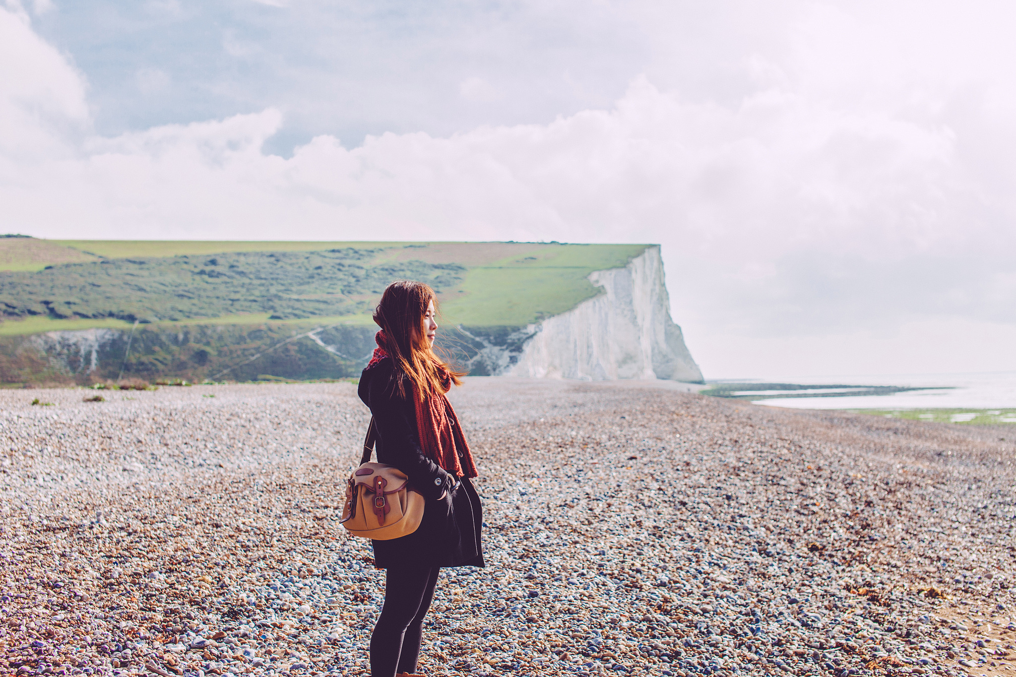 young woman looking at view by the sea