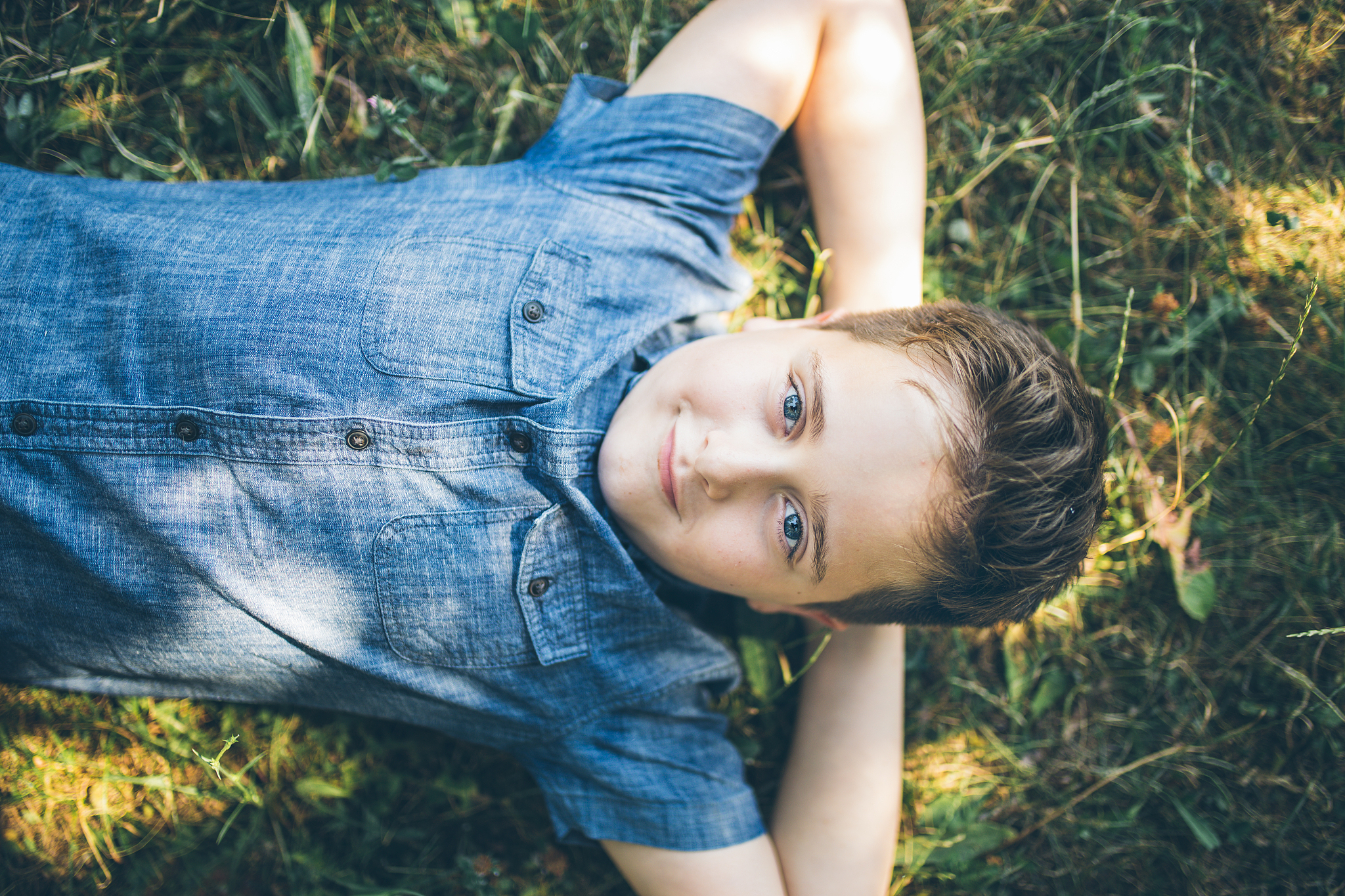 boy with headphones listening to music in park