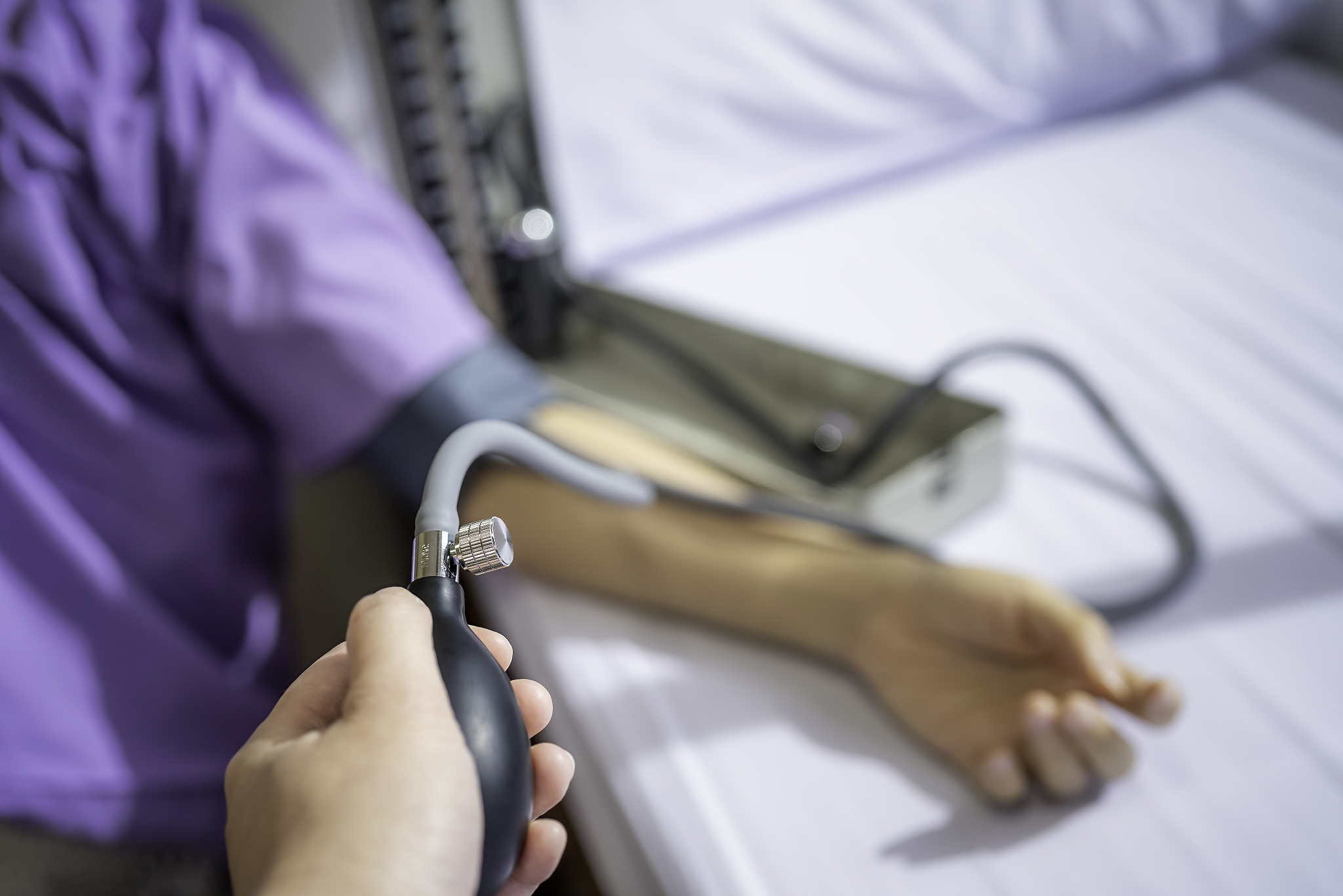 measuring the patient's blood pressure, close up