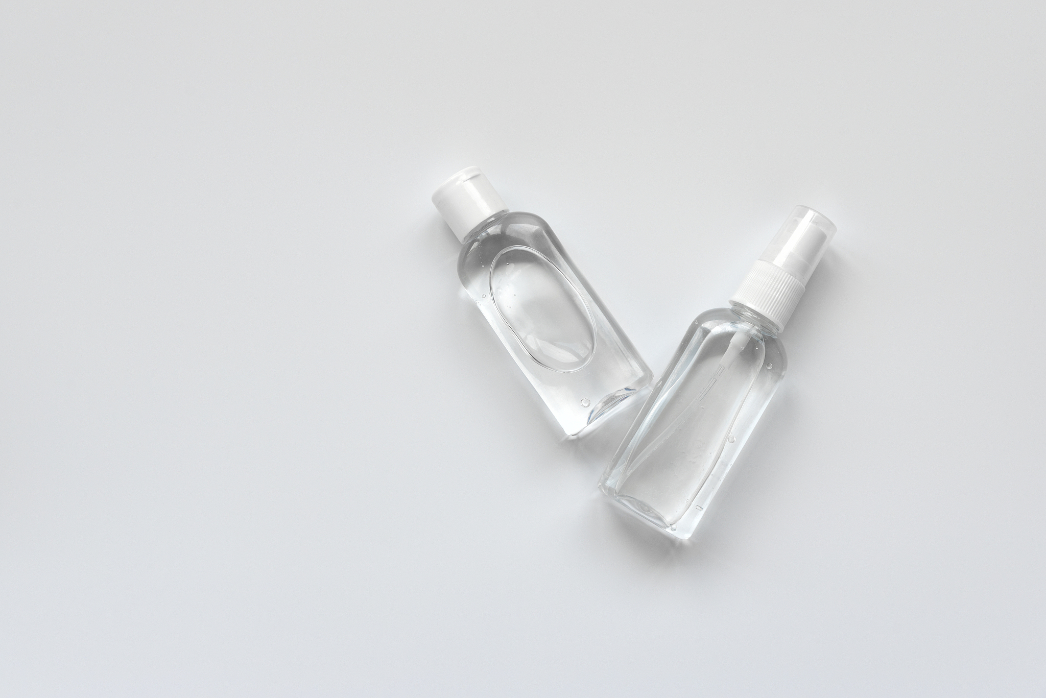 bottles of antiseptic hand gel and spray on white background.  f