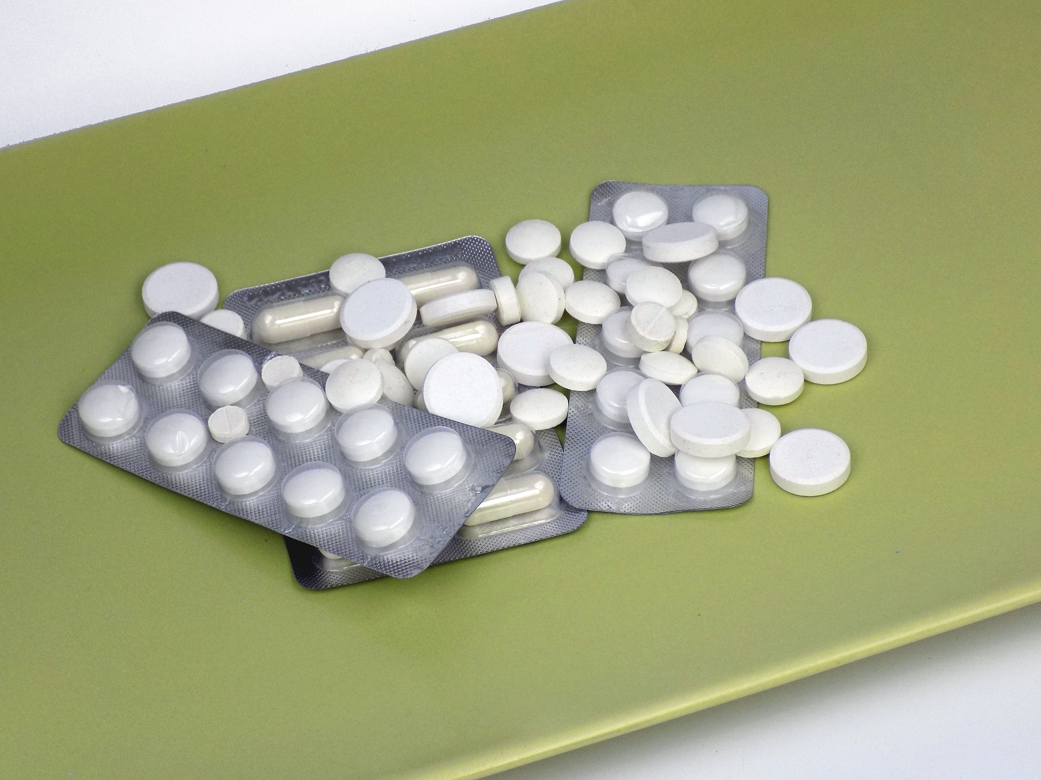 pill of drugs and medicines on the green background