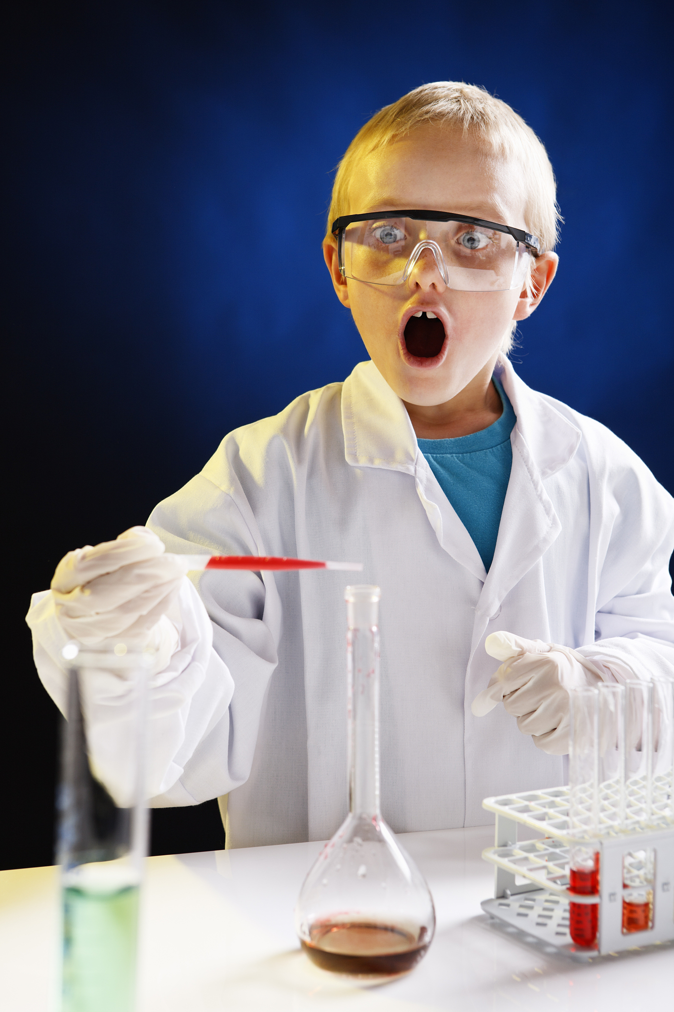 8 year old scientist in lab is amazed by experiment