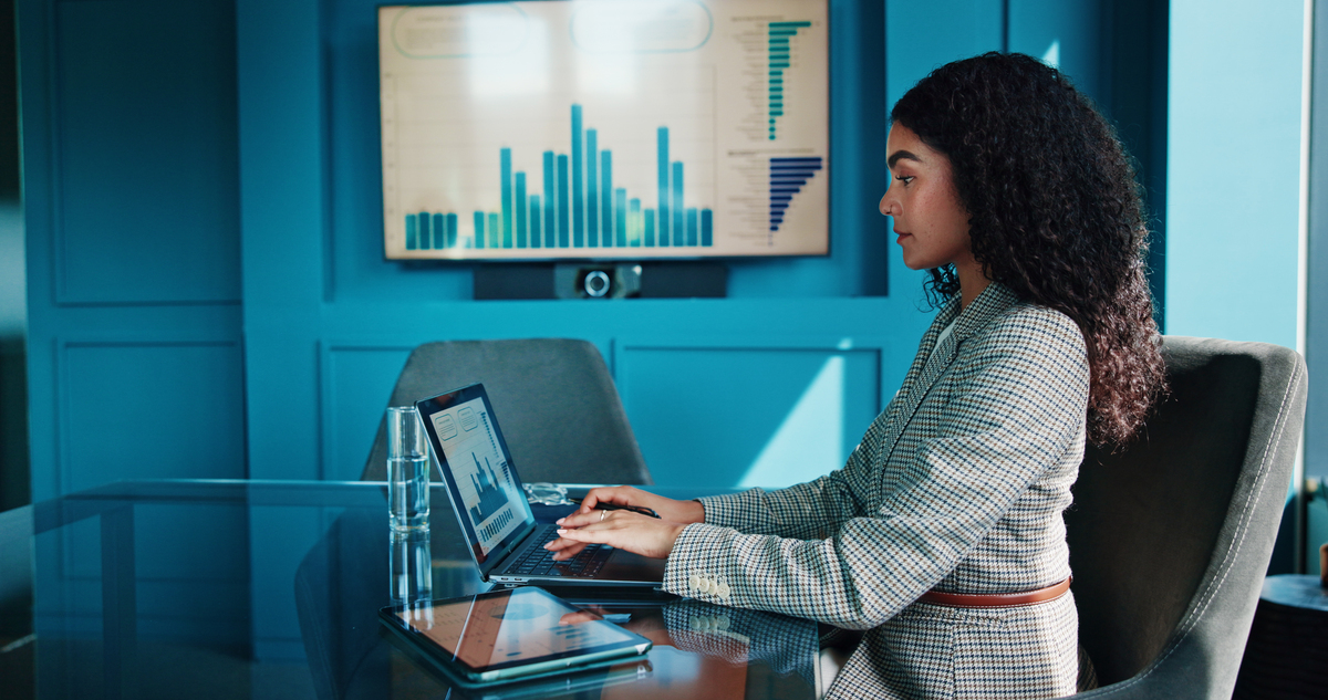 Focused Woman Working Late in Modern Office - High-Resolution Image