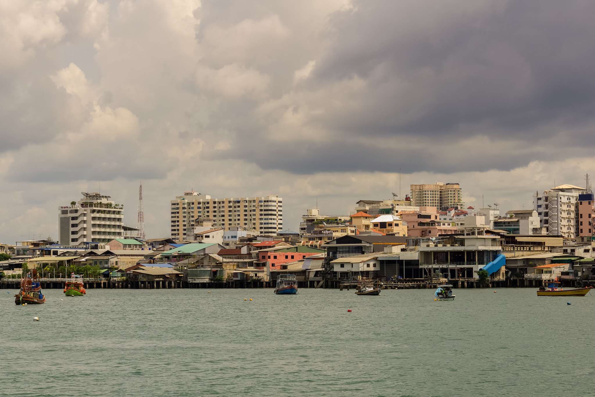 buildings by sea against sky