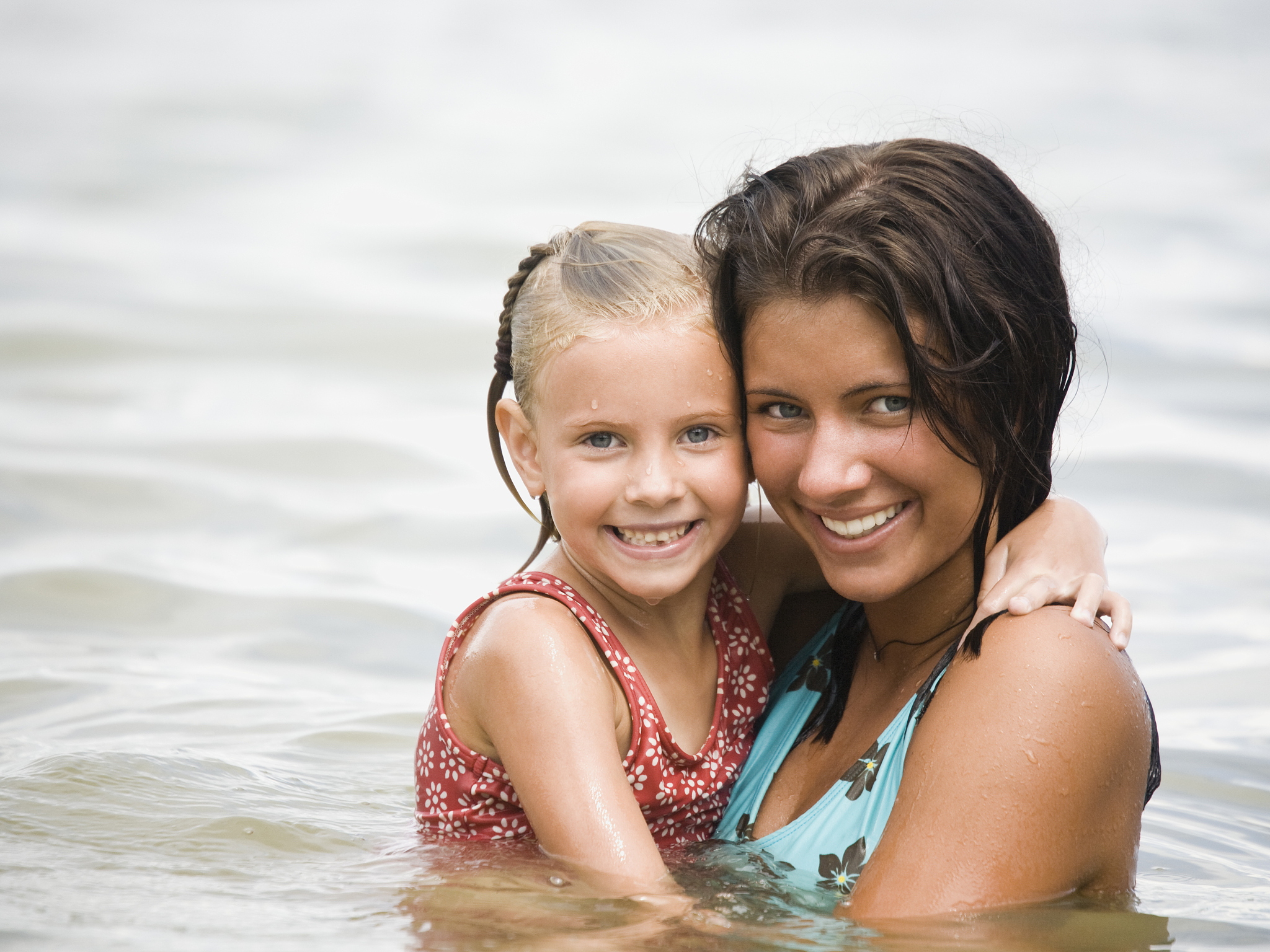 young woman and girl in the water