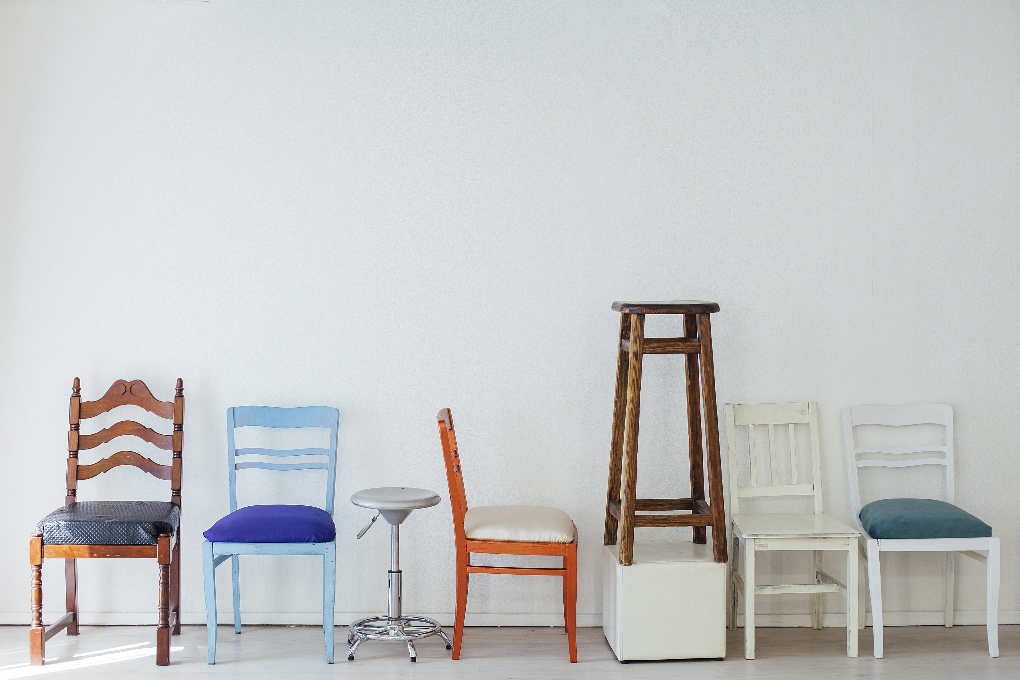 lots of multicolored chairs in the interior of the white room
