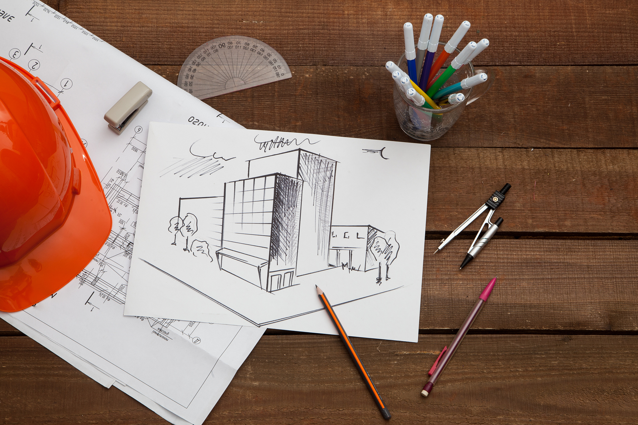 architect drawing blueprints
