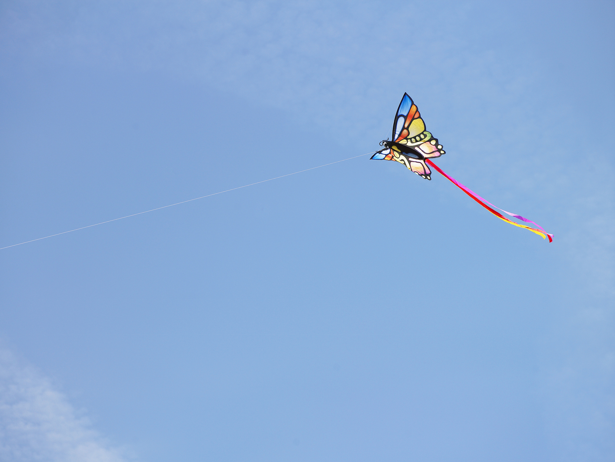 kite flying aginst blue sky