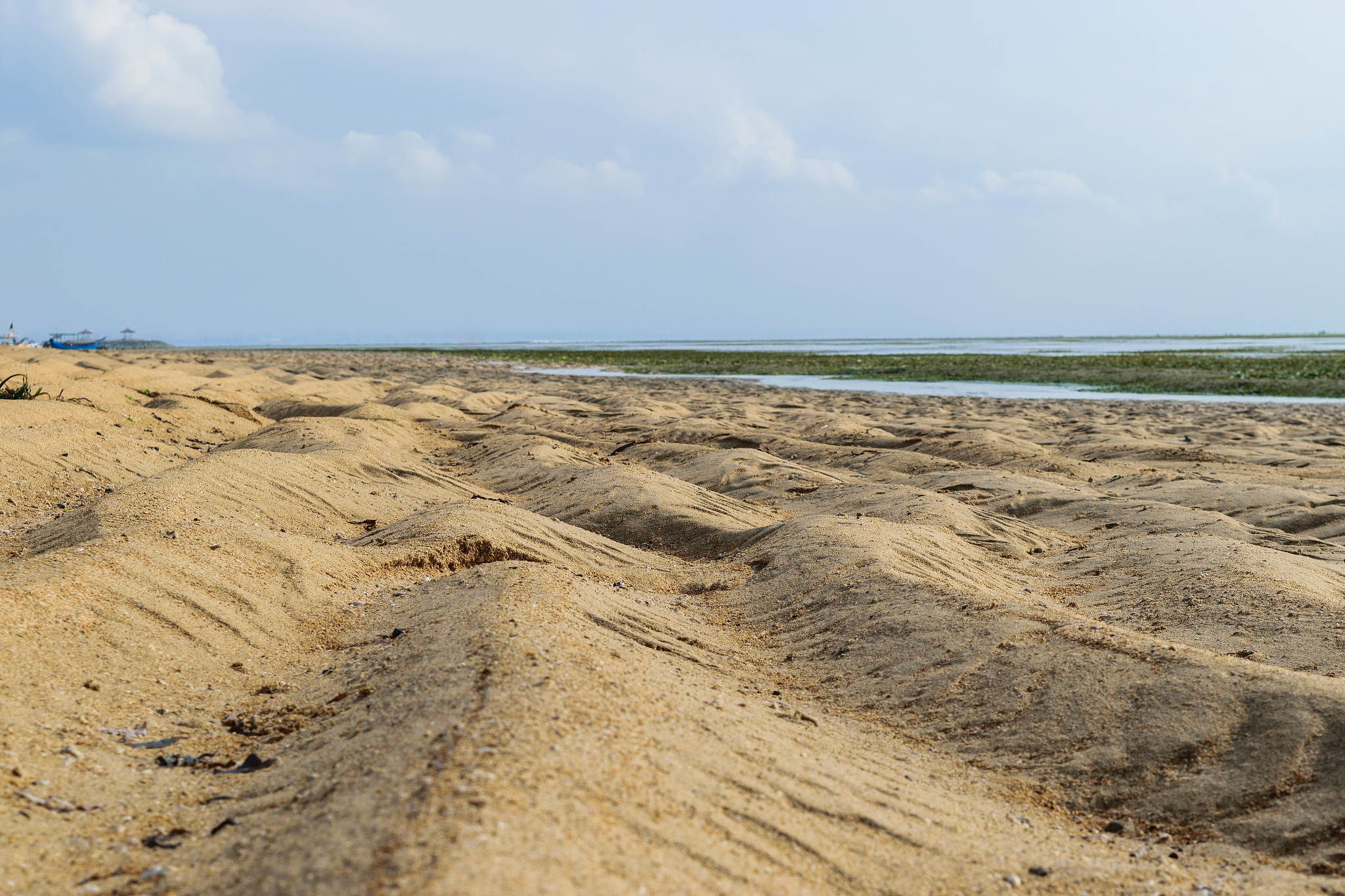 beach during low tides of indian ocean in sanur, bali
