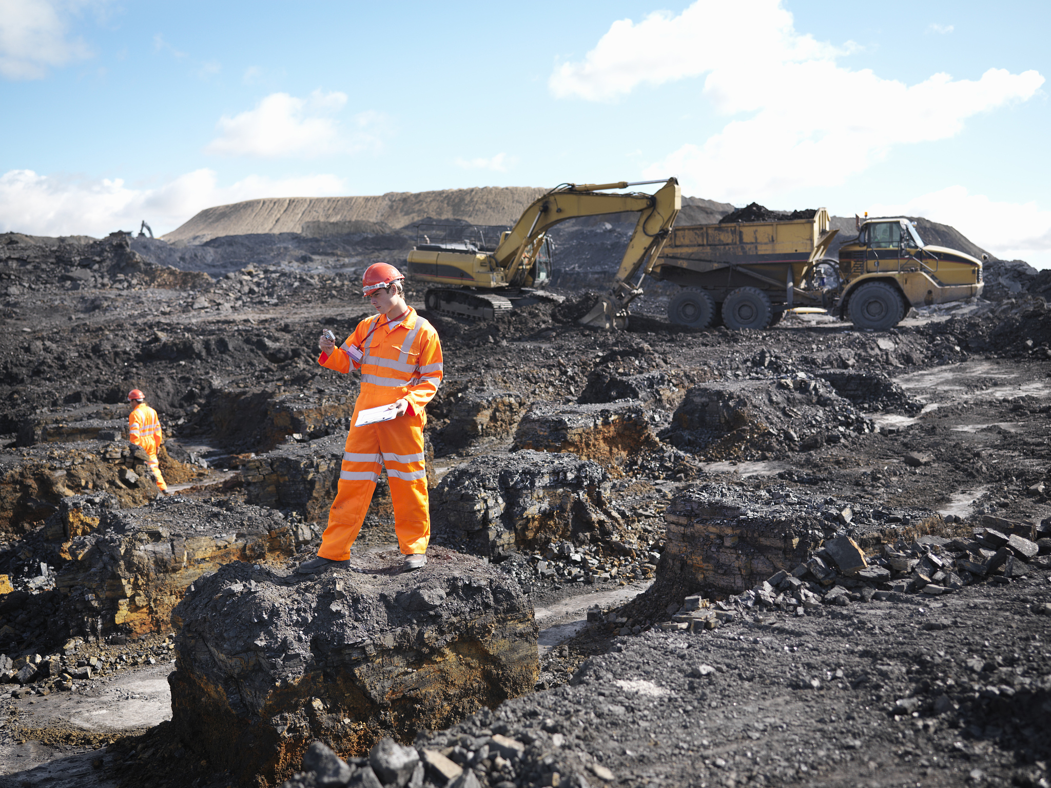 worker surveying coal mine