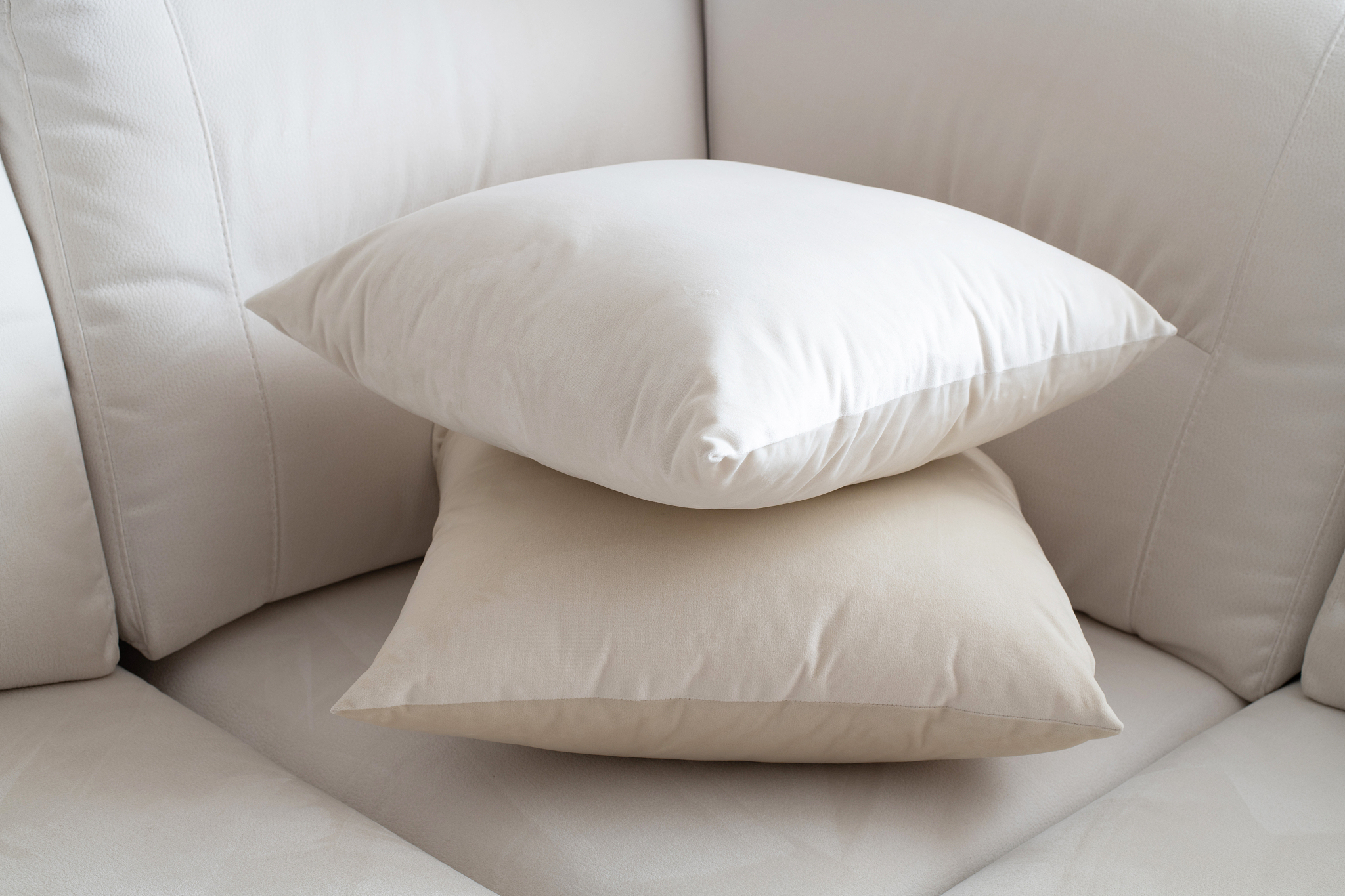two white pillow on the light sofa